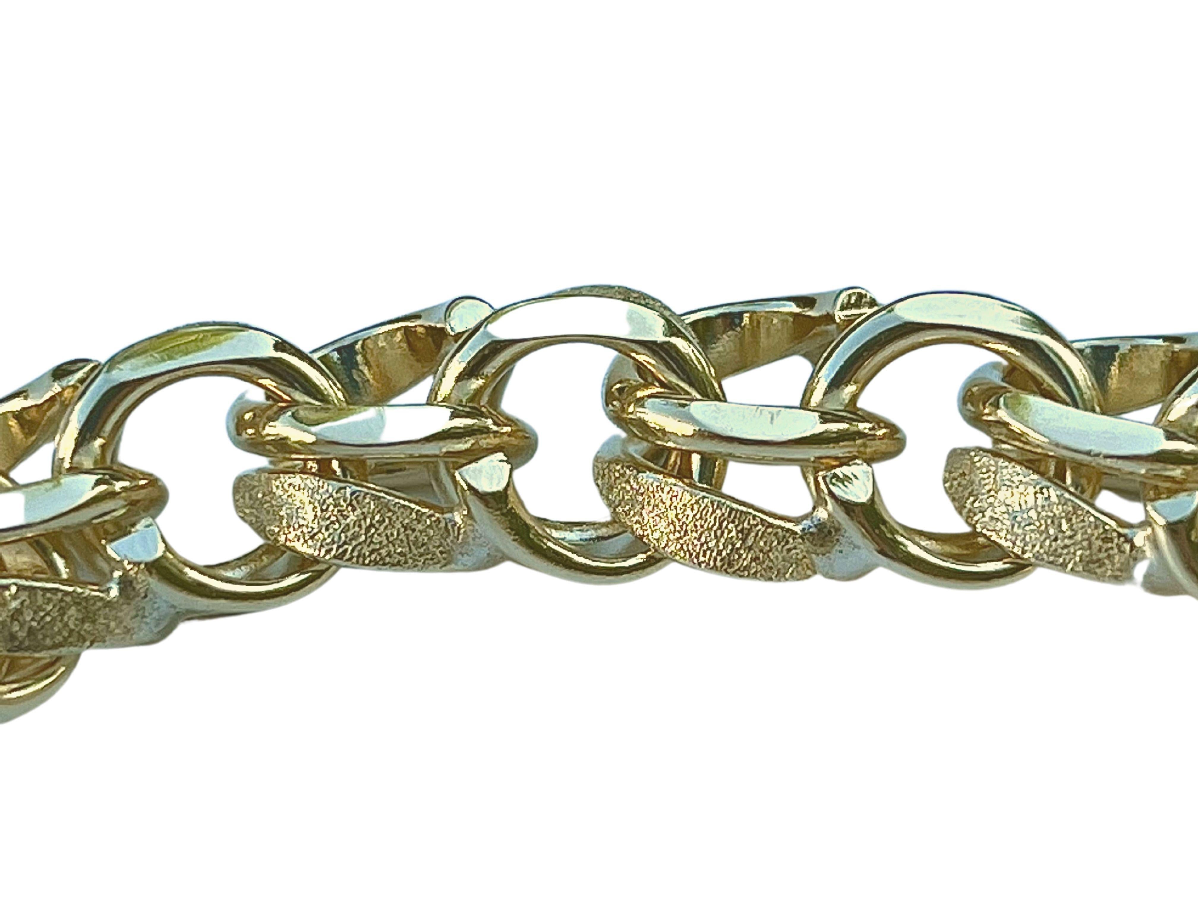 14k solid gold double cable chain link bracelet with box and clip closure. This bracelet is made up of smooth, diamond cut, cable links, and textured circular links of a slightly larger size. This intricate combination of circular links creates a