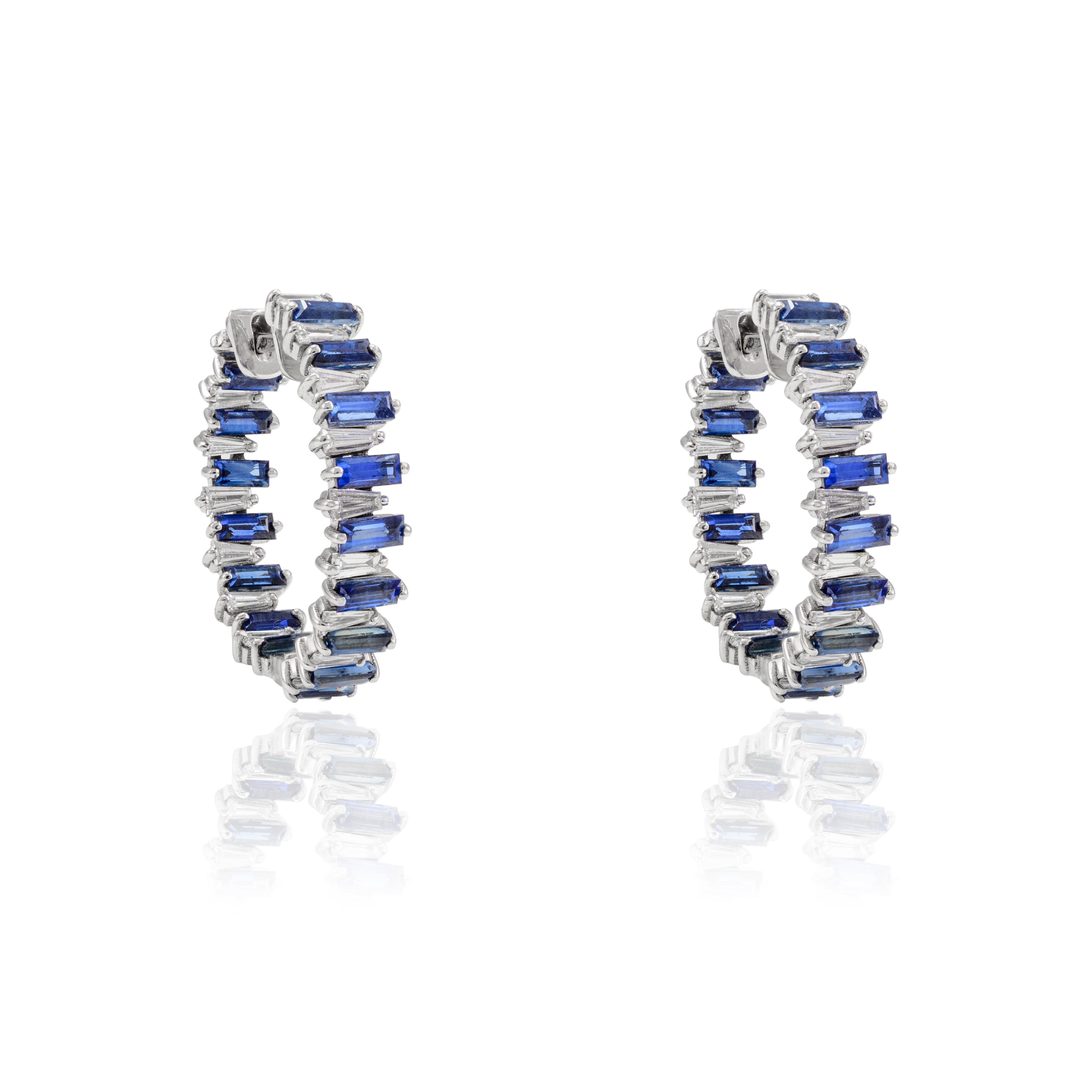 Blue Sapphire and Diamond Hoop Earrings in 14K Gold to make a statement with your look. You shall need stud earrings to make a statement with your look. These earrings create a sparkling, luxurious look featuring baguette cut sapphires and