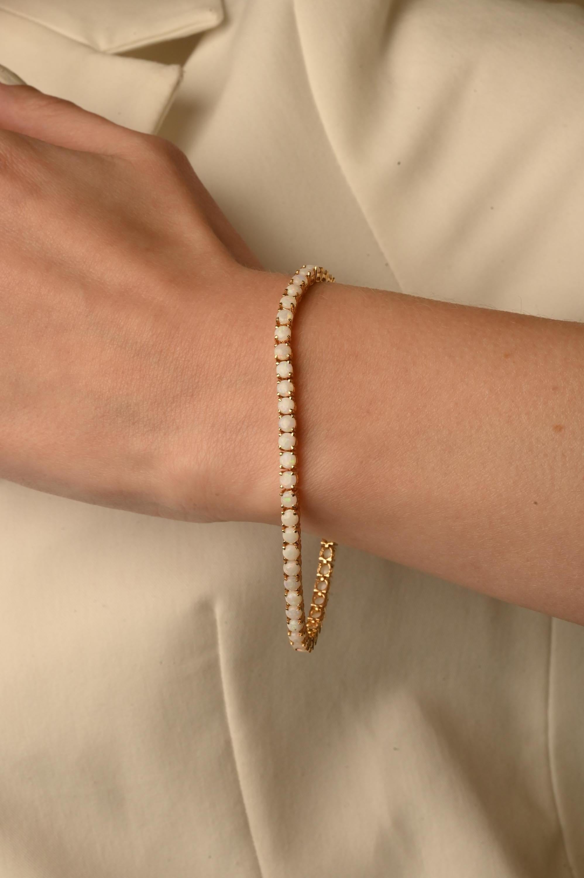 This 4.1 Carat Opal Tennis Bracelet in 14K gold showcases endlessly sparkling natural opal, weighing 4.1 carats. It measures 7.5 inches long in length
Opal helps to find love, good luck, happiness and positivity.
Designed with round cut opal set in