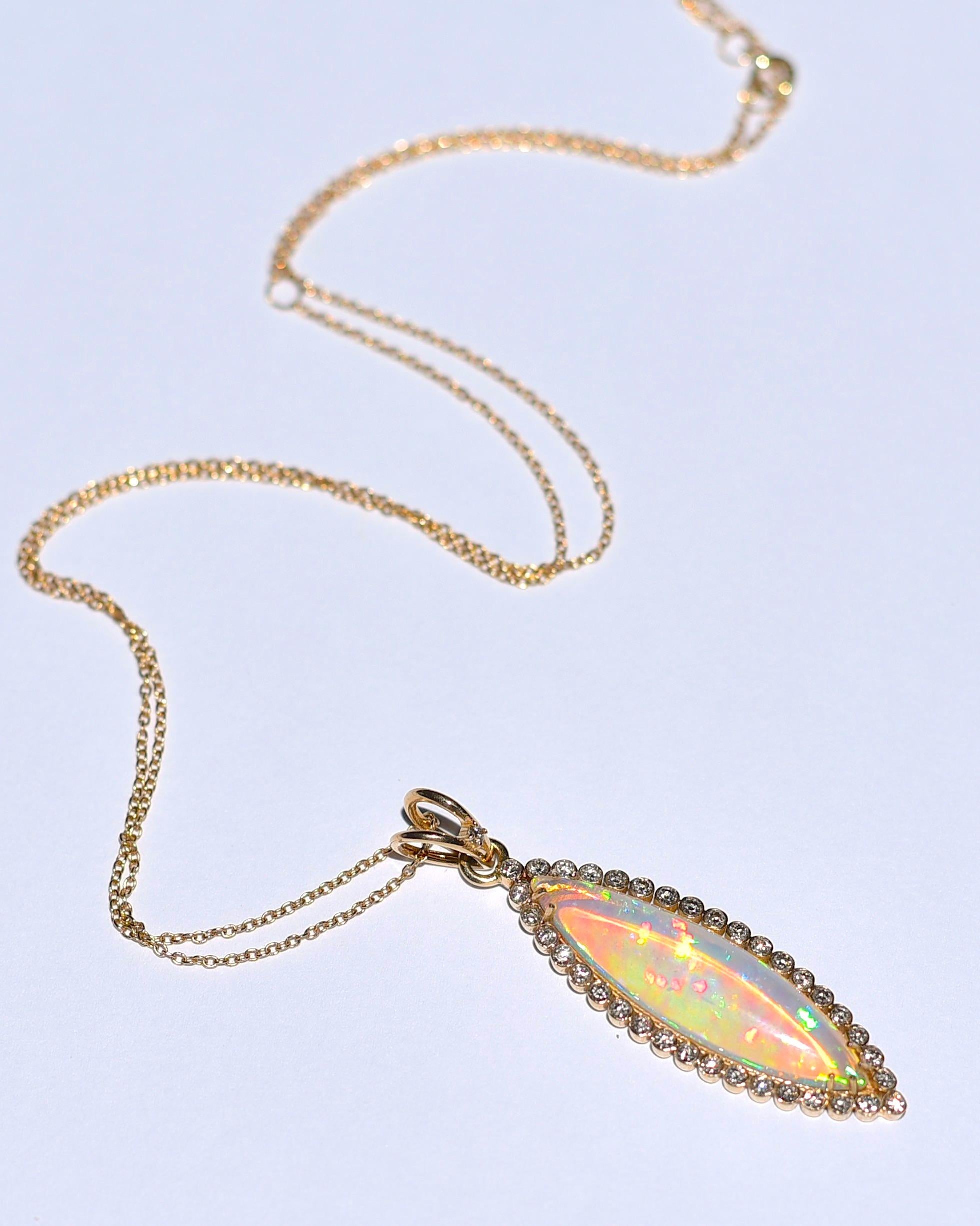 This is the most amazing opal necklace I have ever sold in my shop! This is a manufactured piece of jewelry that I have put up for sale at the best price on the market! 
14k Solid Yellow Gold 4.67CT Marquise Shape Natural Opal 0.64CT Diamond