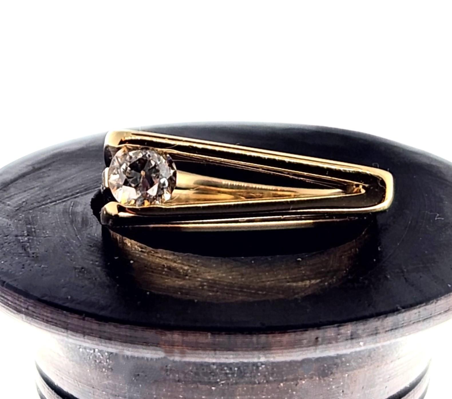 Never designing the same silhouette in her jewelry, Alison Nagasue created a new ring profile and used an old miner cut diamond which has an elegant characteristic.  One side of the ring has 3 