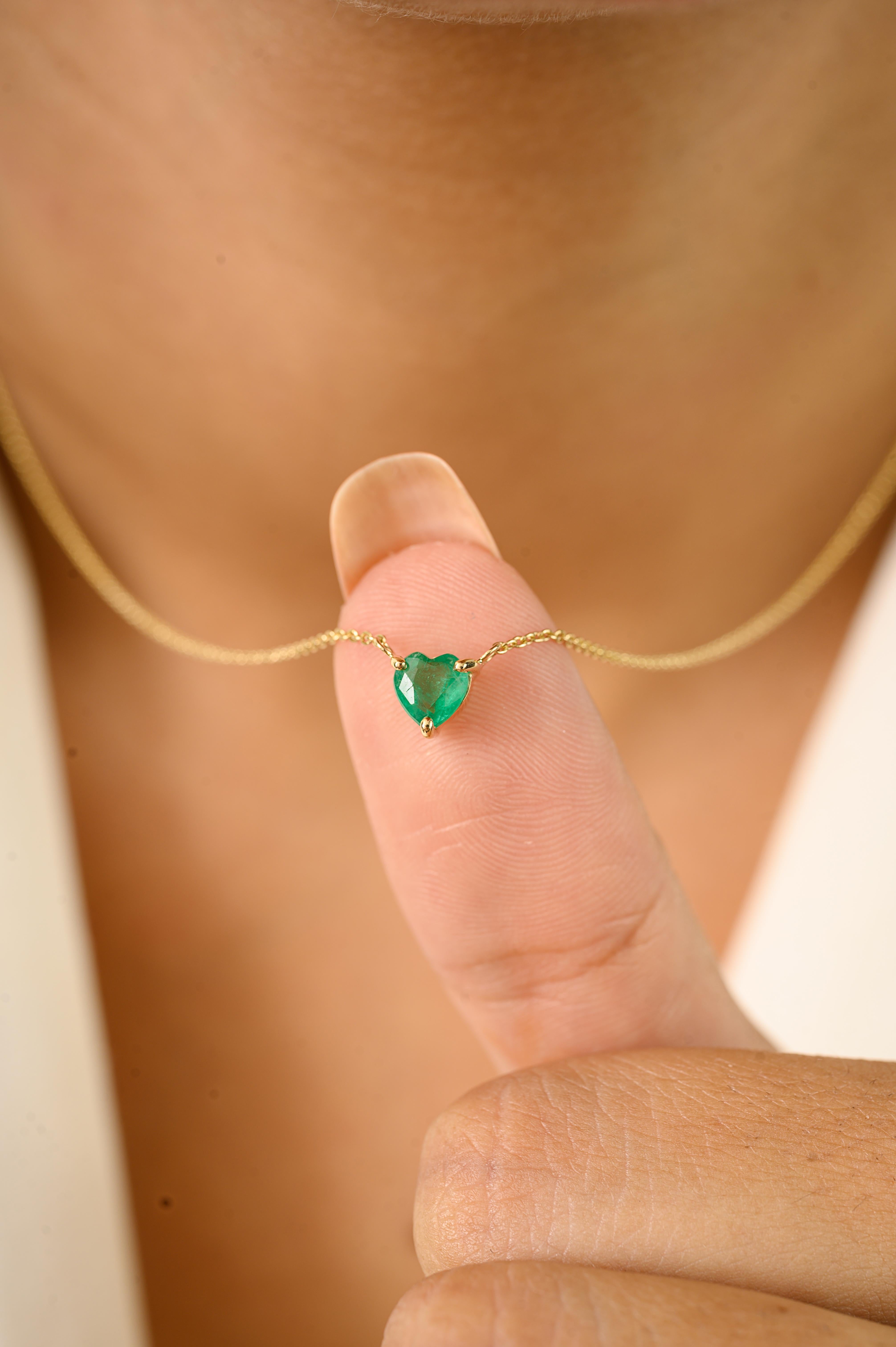 This elegant pendant necklace features a heart-cut natural emerald weighing 0.4 carats, beautifully prong-set in 14K yellow gold for a secure. The pendant is suspended from a sleek gold chain, measuring 18 inches length, designed to highlight the
