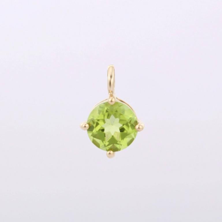 Peridot pendant in 14K Gold. It has a round cut peridot that completes your look with a decent touch. Pendants are used to wear or gifted to represent love and promises. It's an attractive jewelry piece that goes with every basic outfit and wedding