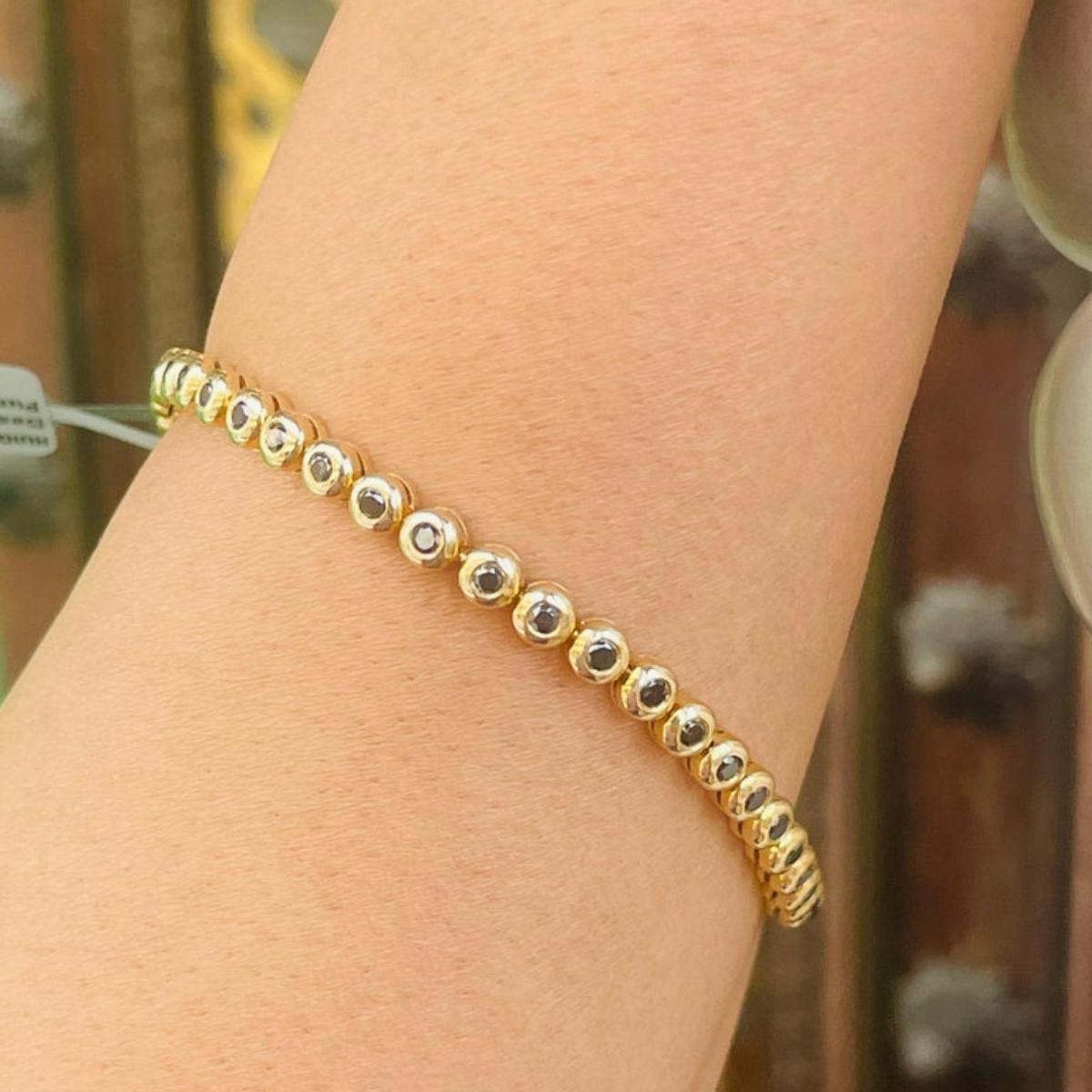 This 14k Solid Yellow Gold Round Cut Mounted Black Diamond Tennis Bracelet showcases sparkling natural diamonds, weighing 1.38 carats. 
April birthstone diamond brings love, fame, success and prosperity.
Designed with diamonds mounted with gold set
