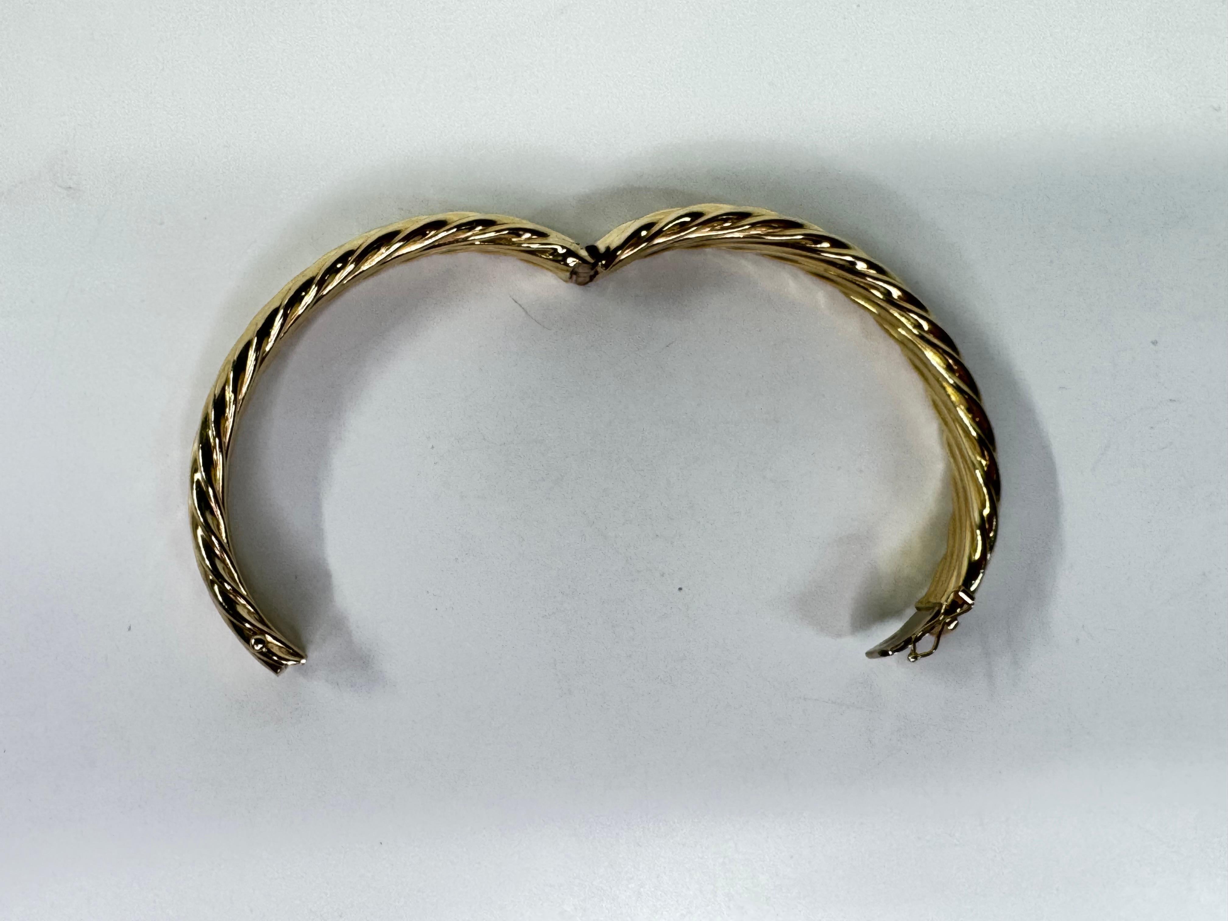 A timeless elegance to your jewelry collection with this 14K Solid Yellow Gold Round Twist-Lid Bangle. Expertly crafted from high-quality 14-karat gold, this bold and stylish piece features a sleek, rounded design with a distinctive twist-lid