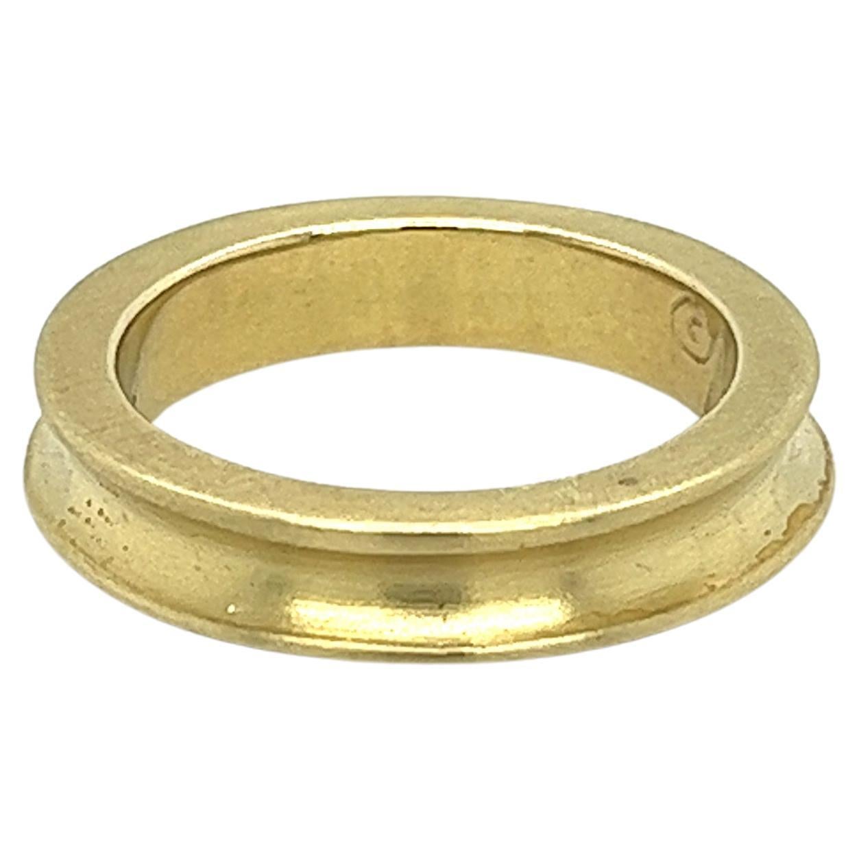 14k solid gold ring by Mignon Faget. This ring features an uneven, curved design that sets it apart from traditional pieces and creates a unique, eye-catching look. The soft brushed gold finish gives the ring a warm, natural feel, making it a