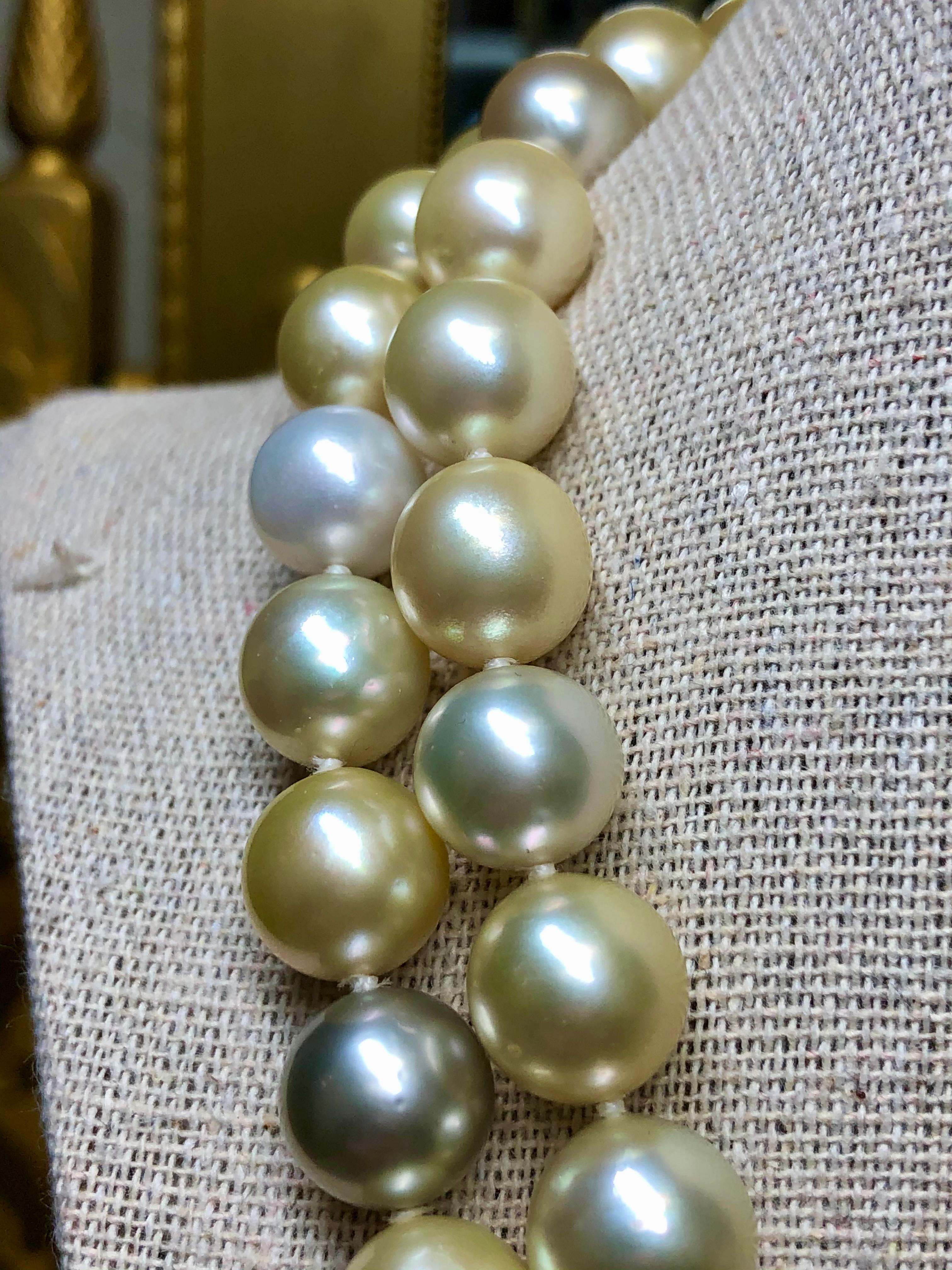 
A classic double strand of multicolored South Sea pearls ranging from 10.50mm at the back to 12.86mm in the front. Very much every-day wearable being that size and having an understated 14K yellow gold barrel clasp. Colors range gray/silver to