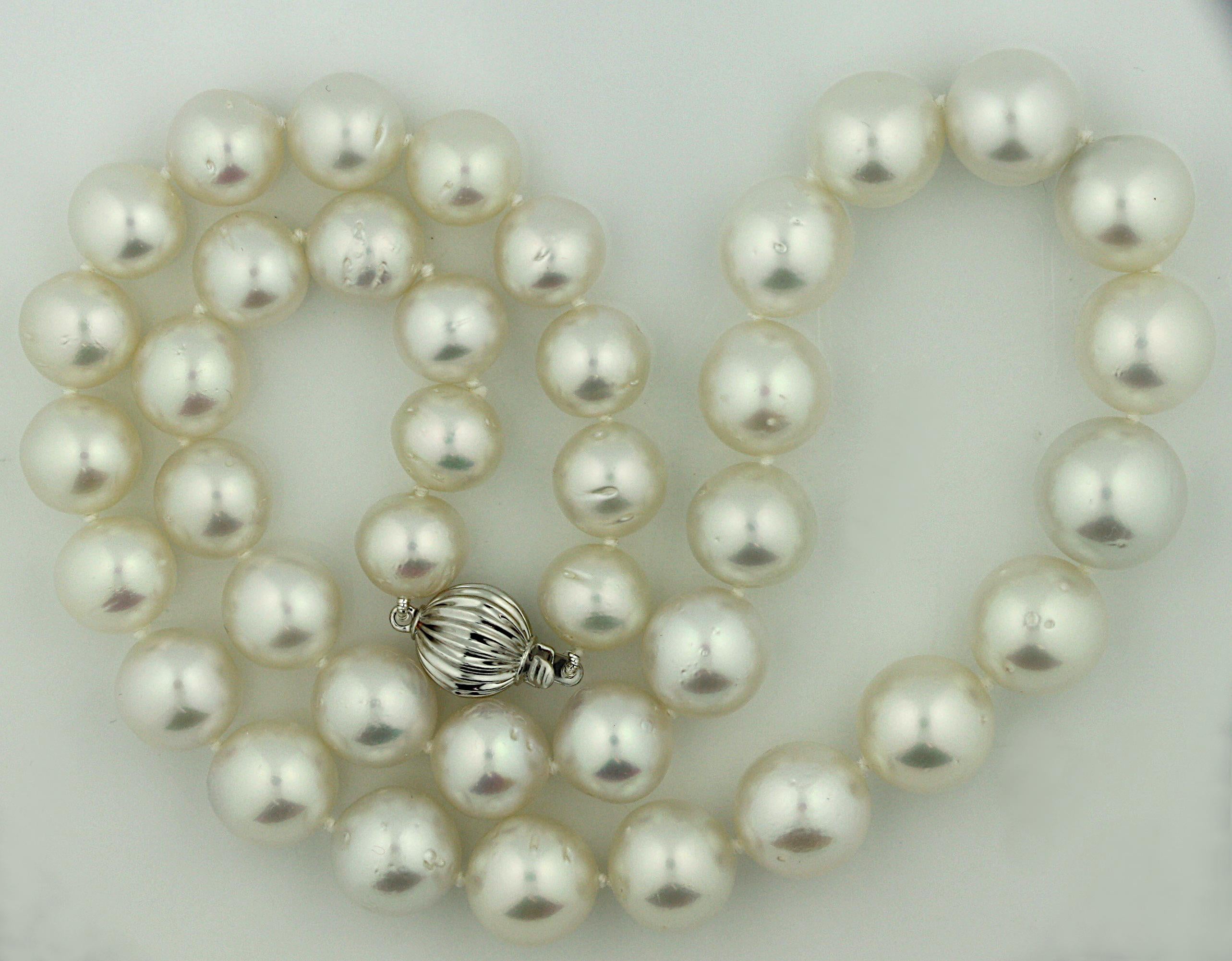 14K South Sea Pearl Necklace 
One single graduated strand composed of thirty-nine white south-sea pearls measuring approximately 10.00 mm to 13.00 mm, completed by a bead clasp. 
Total weight approximately 75 grams