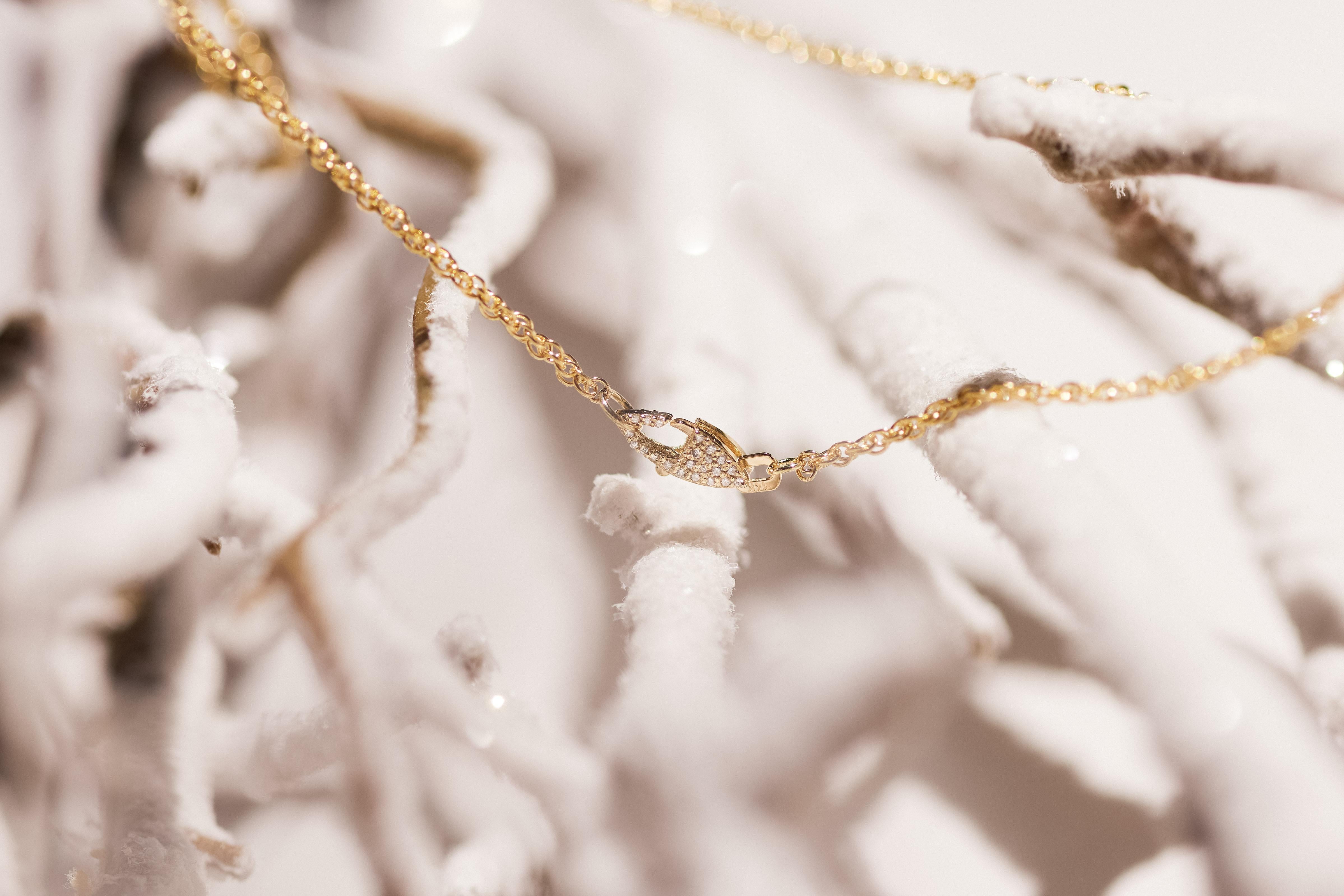 This solid 14k yellow gold chain is elevated by a meticulously crafted hand-pavé double-sided natural diamond clasp, delivering a delicate yet intricately striking statement. Versatile in design, it can be styled with the diamond clasp positioned in
