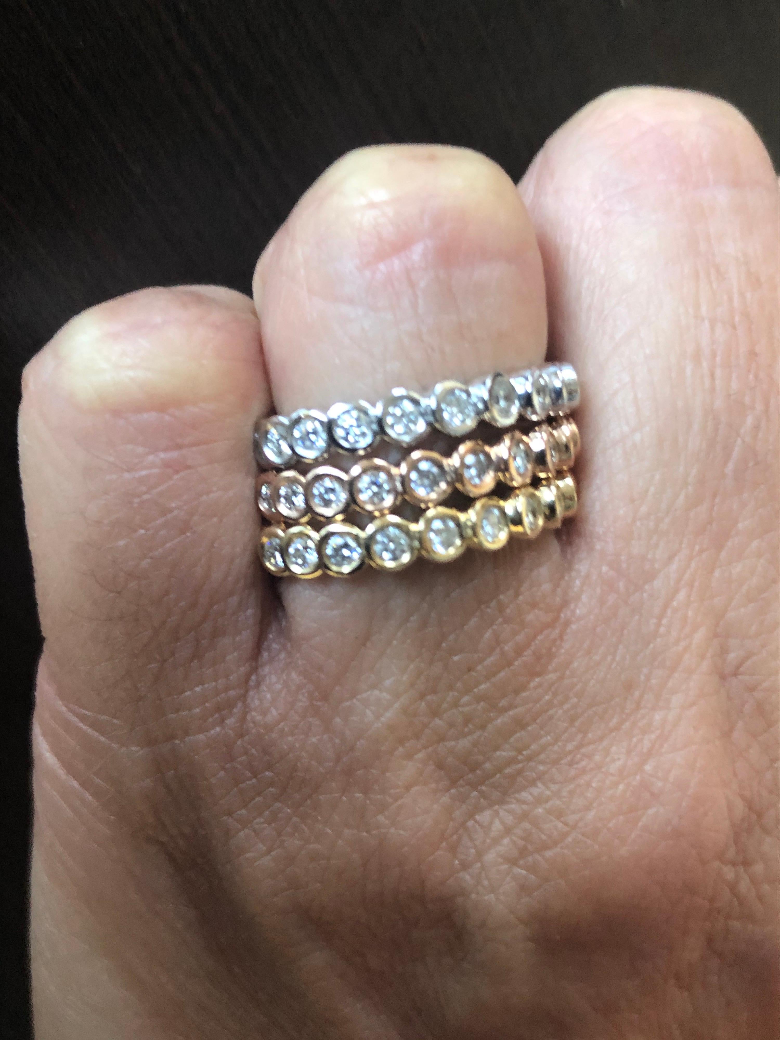 14K White, yellow, and rose gold bezel set rings set 3/4 around eternity. The total weight of each ring is 0.51 carats. Each ring is set with 17 stones. The color of the stones are G-H, the clarity is SI1. The rings are sold as a set.