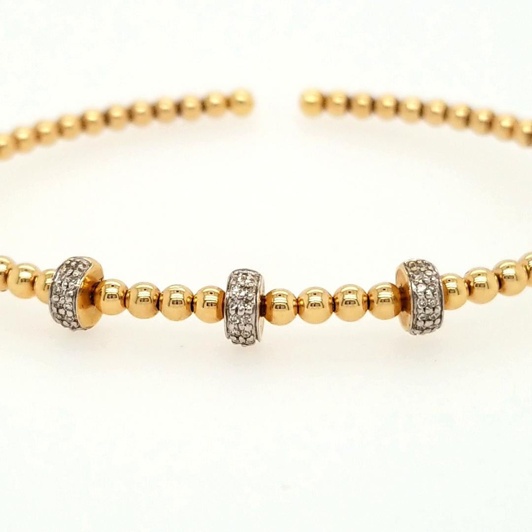 This is a delightful Flexible Bangle Bracelet designed with 3 Diamond Bar accents in 14K Yellow Gold and Stainless Steel. There are approximately 0.12ctw Diamonds, G-H in Color, VS-SI in Clarity sparkling on the top of the bracelet. The Bracelet is