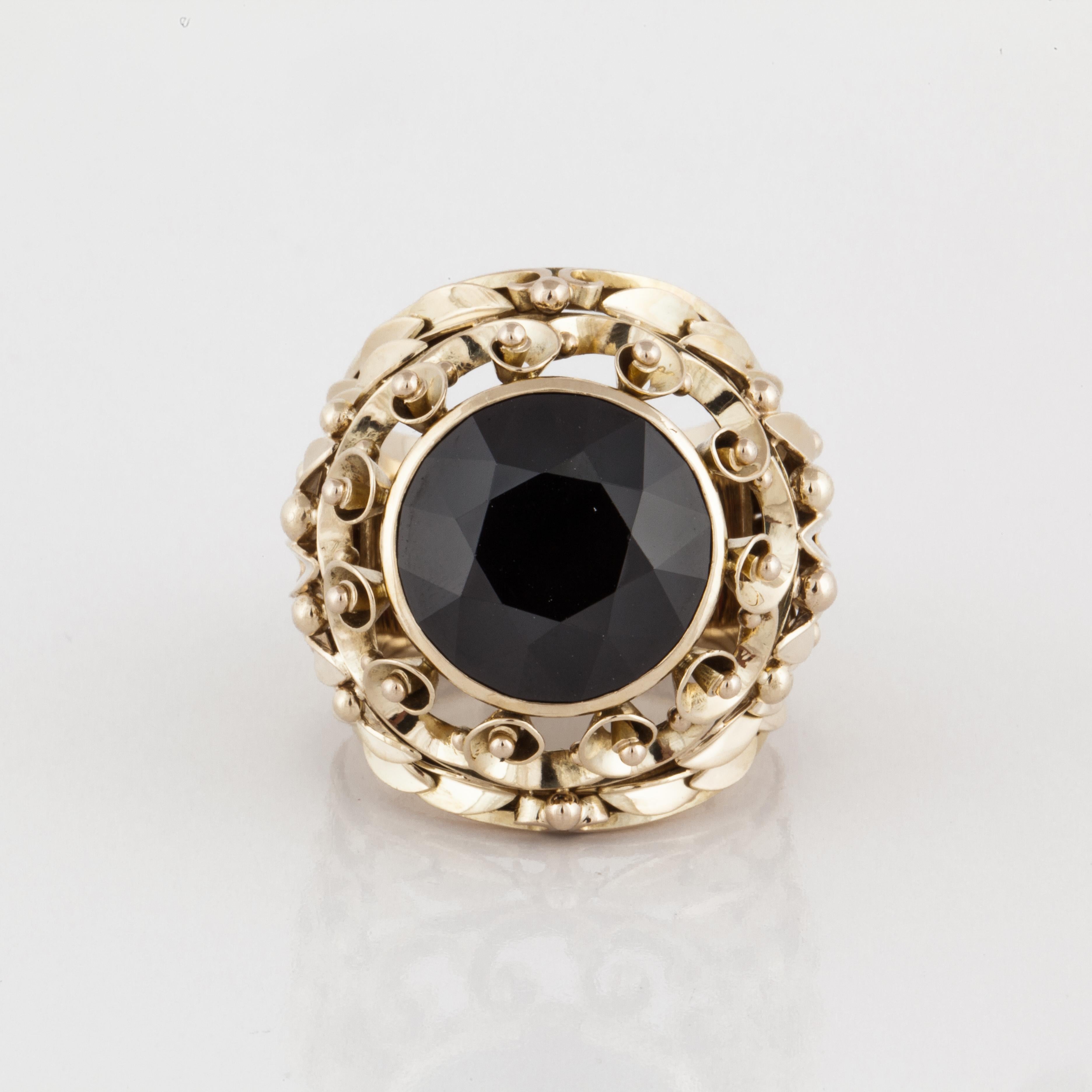 14K yellow gold statement ring with a 21 carat round garnet stone. The intricate gold work is beautiful and highly detailed.  It measures 1 1/8 inches by 1 1/8 inches and stands 1/2 an inch off the finger. Ring is a size 9.