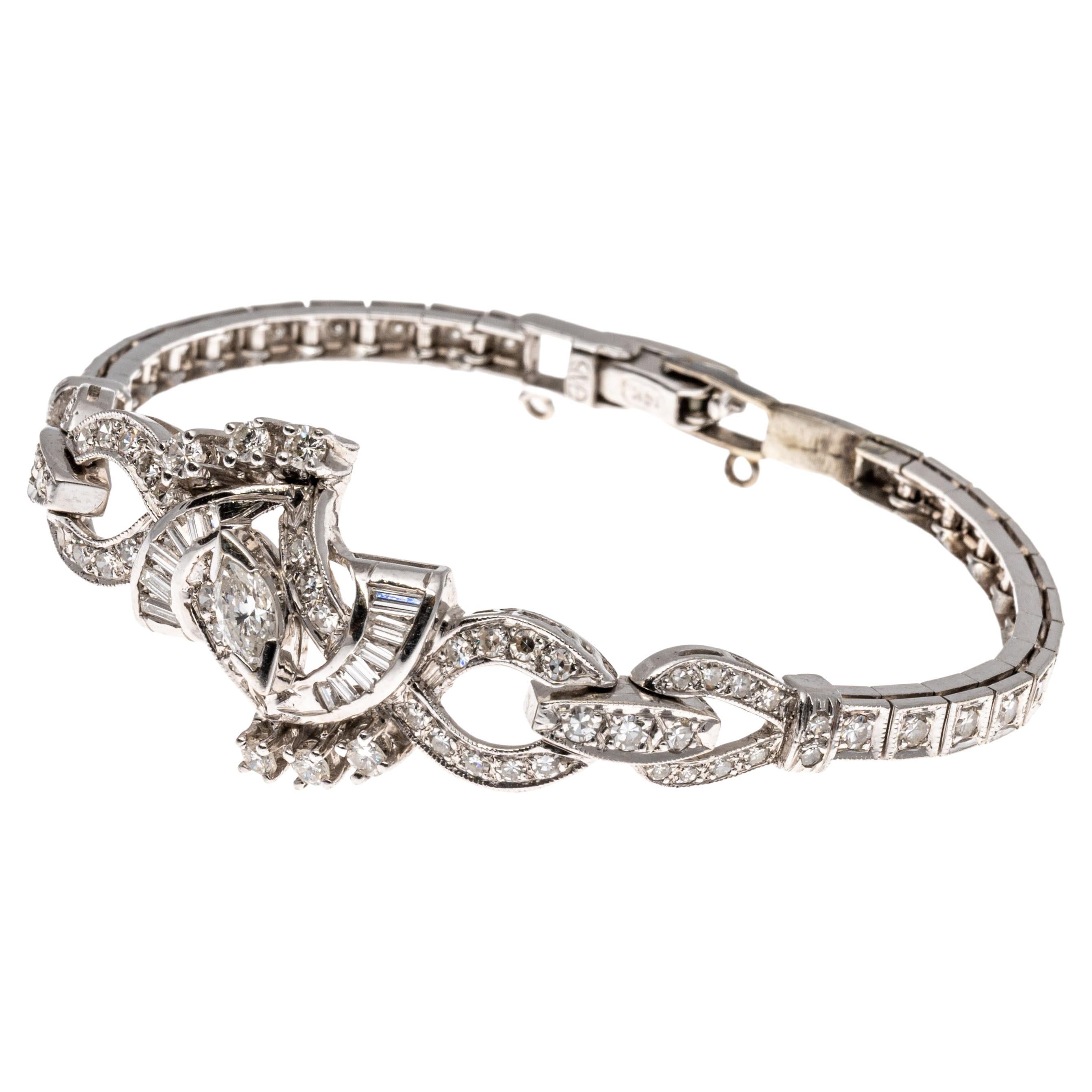 14k Stunning Bracelet, App 1.15 TCW With Marquise, Baguette And Round Diamonds.
This stunning bracelet highlights a center stone which is a marquise brilliant shaped diamond, approximately 0.15 CTS, and set with 