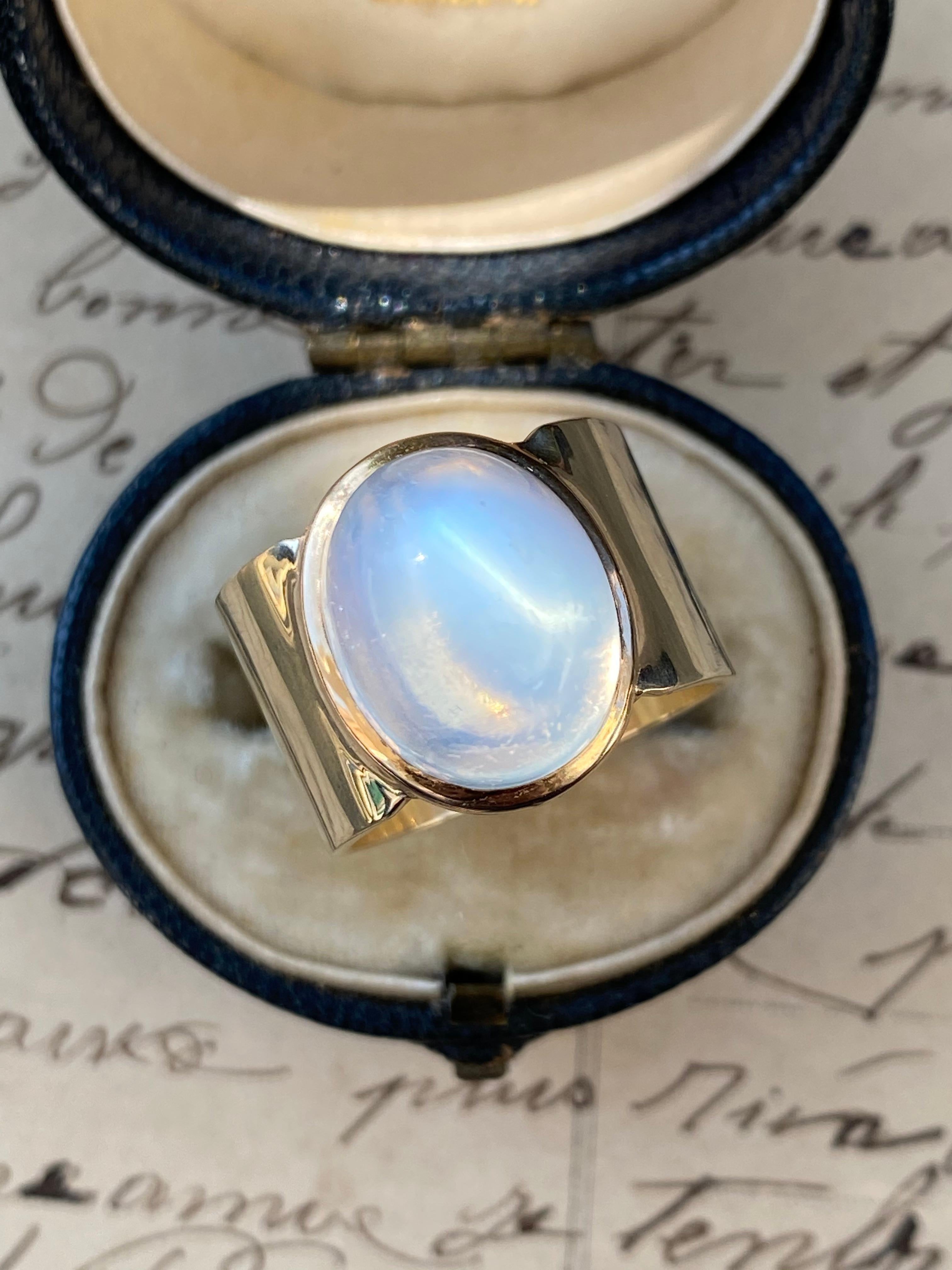 This luminous sugarloaf moonstone was once a lonely stickpin I reimagined as a ring with a wide 12mm 14k gold band. The sugarloaf moonstone is approximately 10.5 carats, measuring 13.54 x 10.80 x 9.98 deep. Size 6

High-quality moonstones that