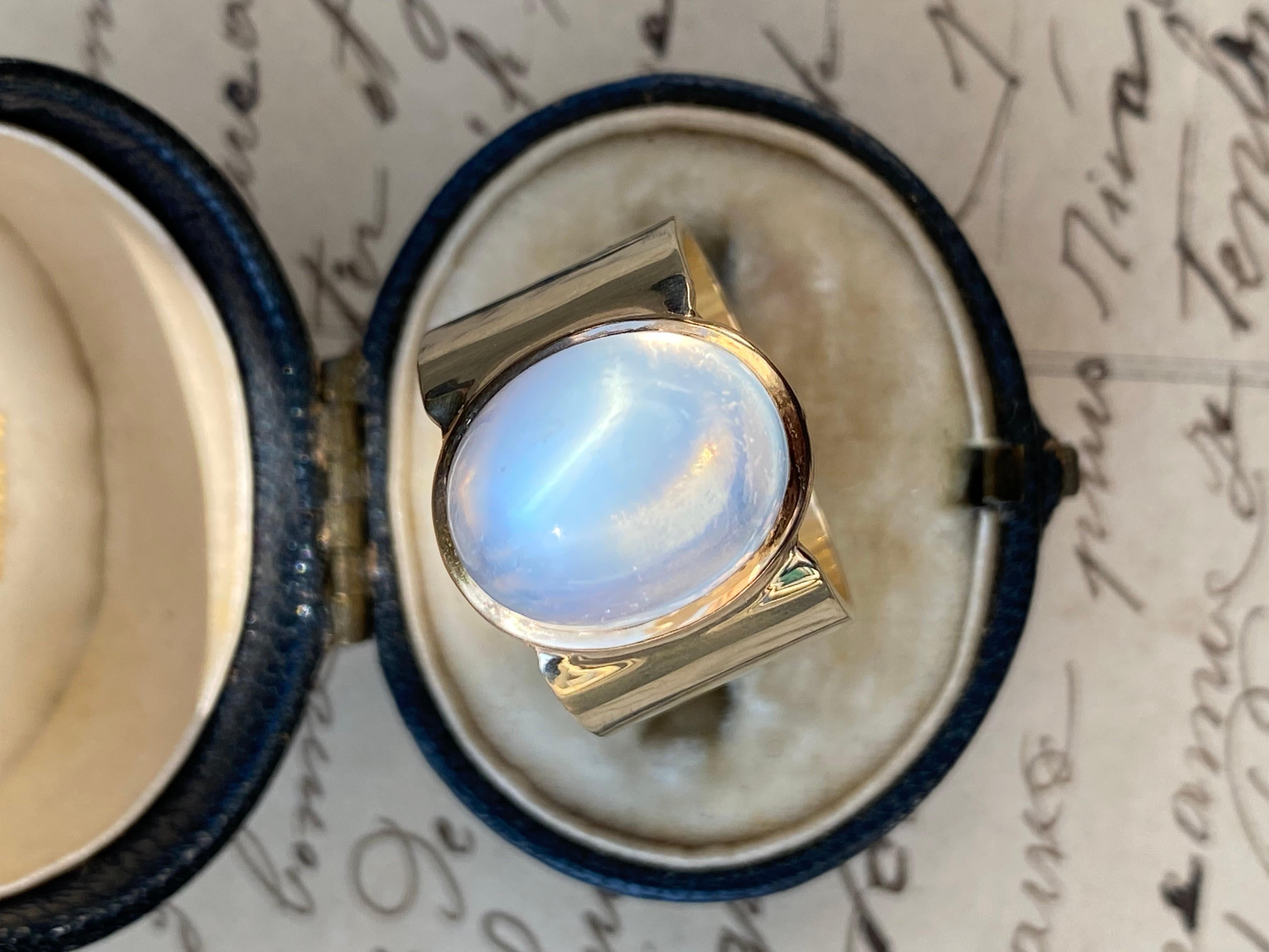 This luminous sugarloaf moonstone was once a lonely stickpin I reimagined as a ring with a wide 12mm 14k gold band. The sugarloaf moonstone is approximately 10.5 carats, measuring 13.54 x 10.80 x 9.98 deep. 

Size: 5

Band: 12 mm

Notes: This ring