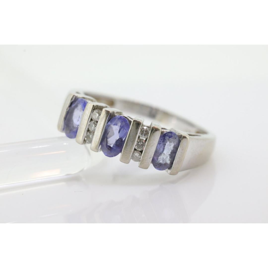 Women's 14k Tanzanite Oval and Diamond Channel Anniversary ring. Channel set eternity For Sale