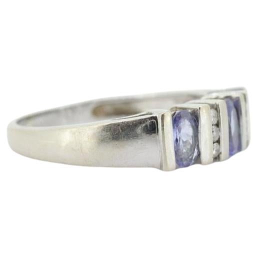 Vintage
Materials: Stone
Gemstone: Tanzanite
Gem color: Blue
Style: Minimalist
Very beautiful Tanzanite and diamond Anniversary ring.

Condition shows some signs of wear.

Details
Size 8
14 Gold 3.5Grams total
3mm by 5mm oval tanzanites 3