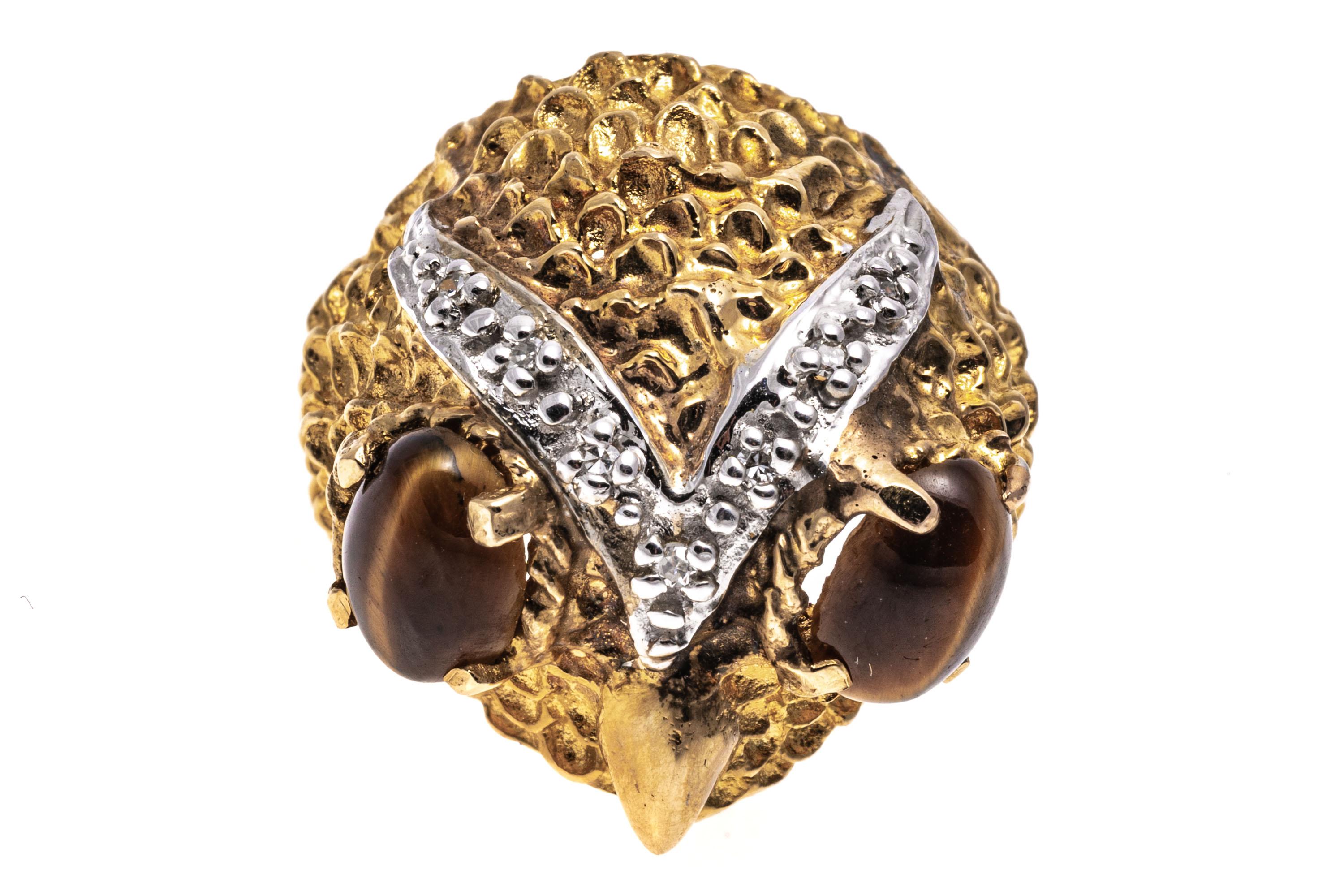 14k Yellow Gold Delightful Textured Owl Head Ring With Diamonds, 0.05 TCW
This delightful ring is an owl head motif, decorated with matte, textured feathers, a high polished beak and two oval cabachon cut tigers eye eyes, prong set. Decorating the