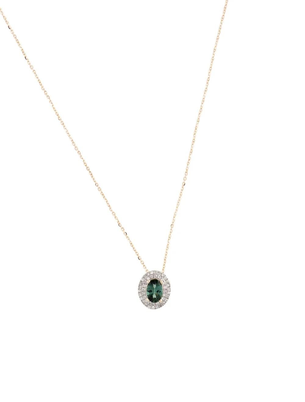 This exquisite pendant necklace features a harmonious blend of rhodium-plated and 14K yellow gold, creating a stunning contrast that enhances its overall allure. The focal point of this piece is an elegant oval modified brilliant tourmaline, exuding