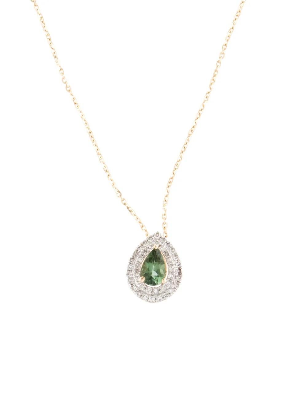 Elevate your style with this exquisite 14K Yellow Gold Pendant Necklace, featuring a stunning 0.36 Carat Pear Brilliant Tourmaline and 0.22 Carats of sparkling Diamonds. This timeless piece exudes elegance and sophistication, perfect for any