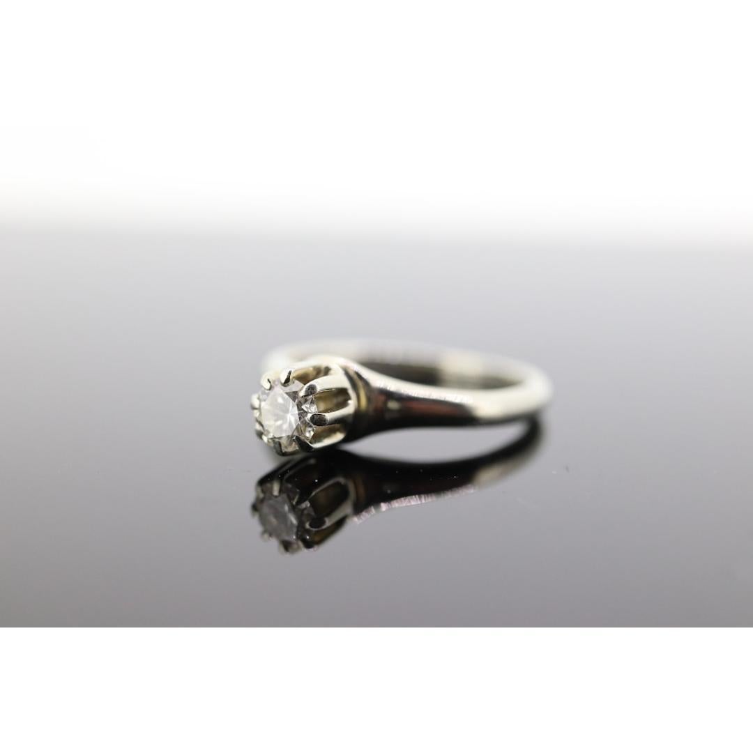 Vintage from the 1920s
Materials: Gold
Gemstone: Diamond
Band color: Gold
Beautiful Antique Diamond Solitaire Ring. Marked Traub Orange Blossom.

Condition: Shows little to no signs of wear. Tests as High 14k Gold.

Details:
Sz 3.5
2mm wide