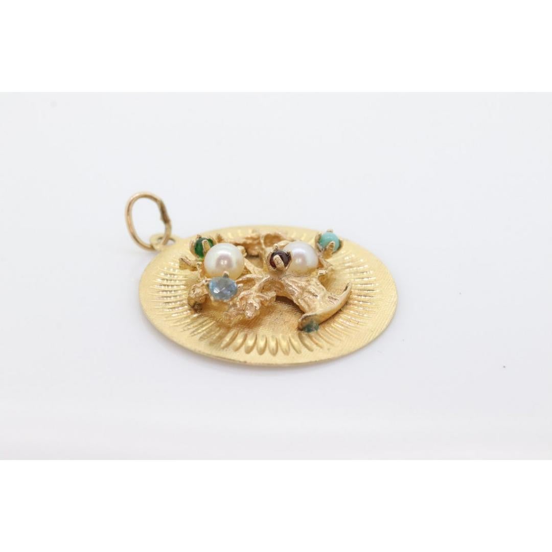 Vintage
Materials: Stone

Gemstone: Amazonite

Amazing Tree of Life Pendant Medallion. 14k Yellow gold. Crafted tree with gems as fruits: Turquoise, Pearl, Ruby, Emerald, and Aquamarine.

Just a wonderful addition to your necklace.

3.8grams total