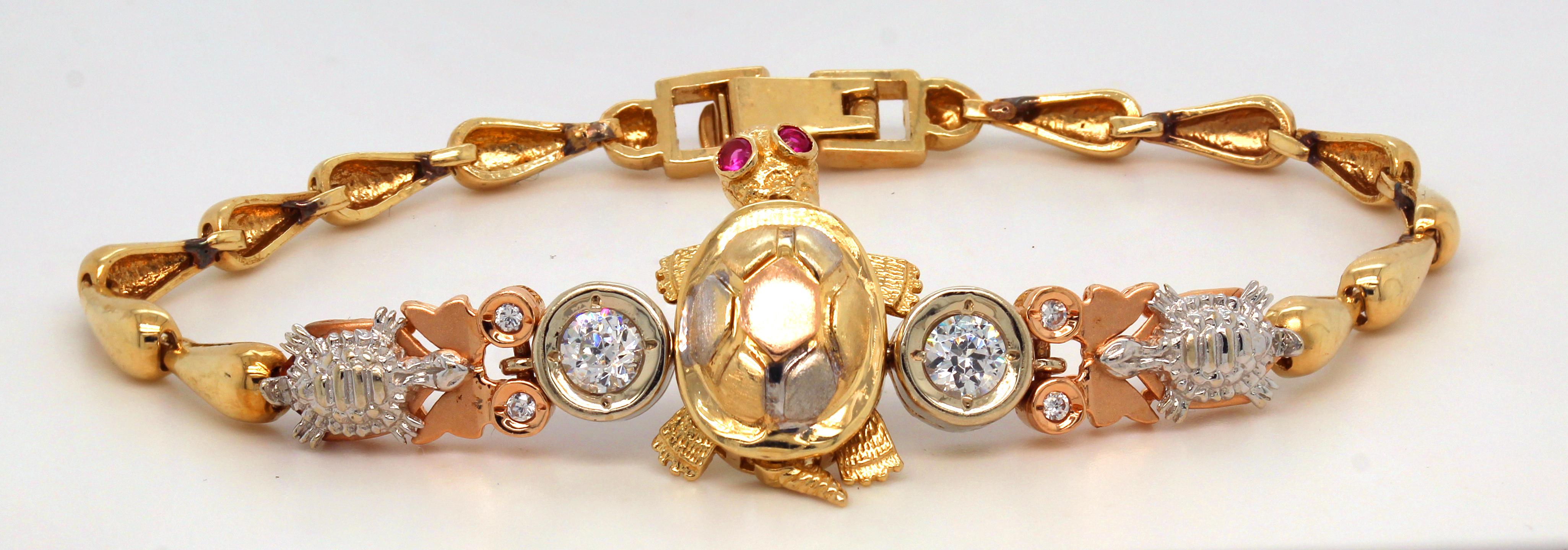 14K Yellow White and Rose Gold Turtle Bracelet with diamonds and ruby eyes

The paws and feet of the turtle dangle and have rubys set in both eyes along with two diamonds on both sides of the shell.

Apprx. 0.70ct. diamonds total weight

Bracelet is