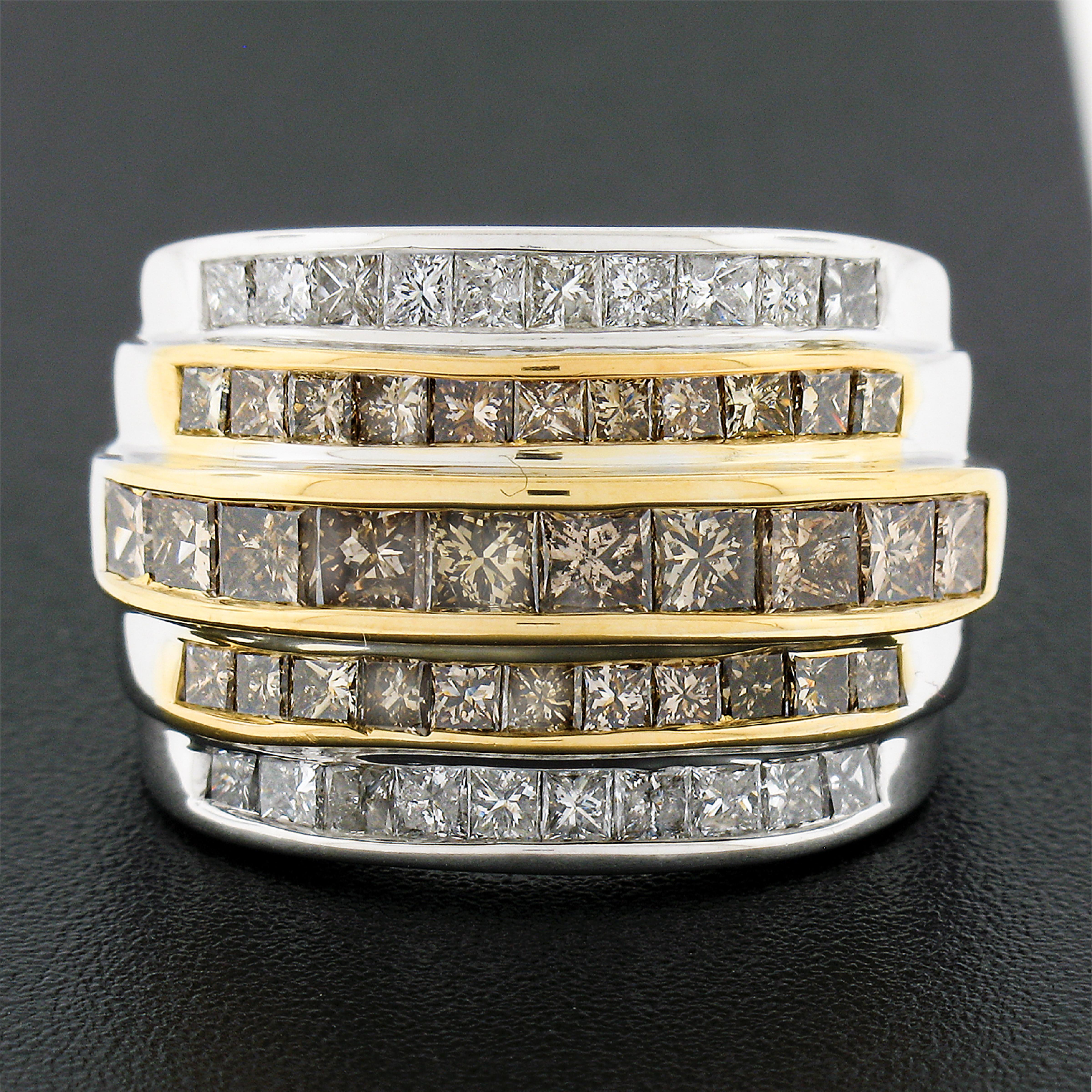 This magnificent and very well made diamond band ring was crafted from solid 14k white and yellow gold and features 5 tiered channels of fancy yellowish brown and white diamonds which total approximately 3.90 carats in weight. These diamonds are