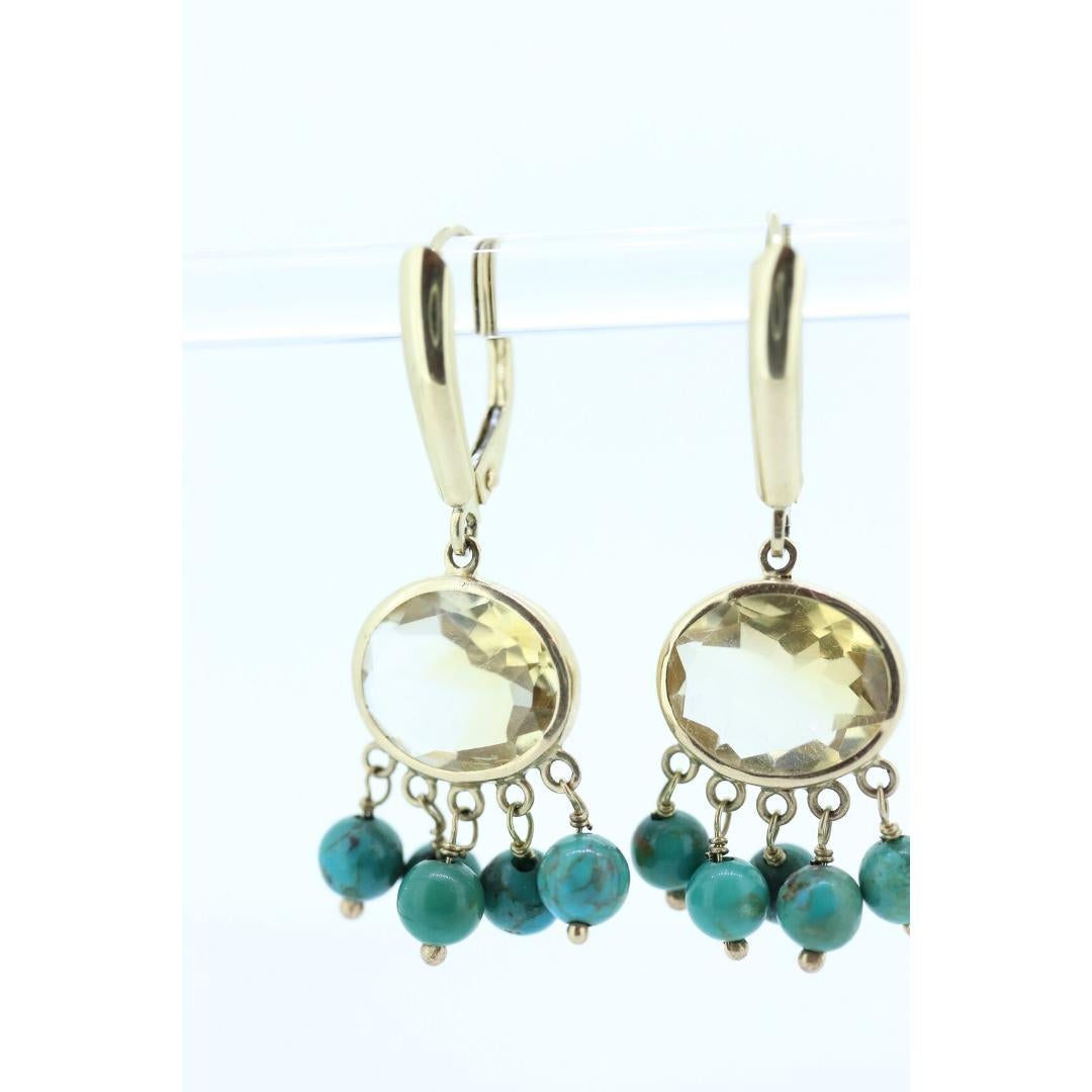 Vintage from the 1980s
Materials: Gold
Gemstone: Turquoise

Jewelry type: Earrings

Beautiful Earring Set.

Made by ZB.

Item Details: These unique earrings have bezel set oval citrine gemstones and turquoise bead dangles.

Circa: 1960s
Metal Type: