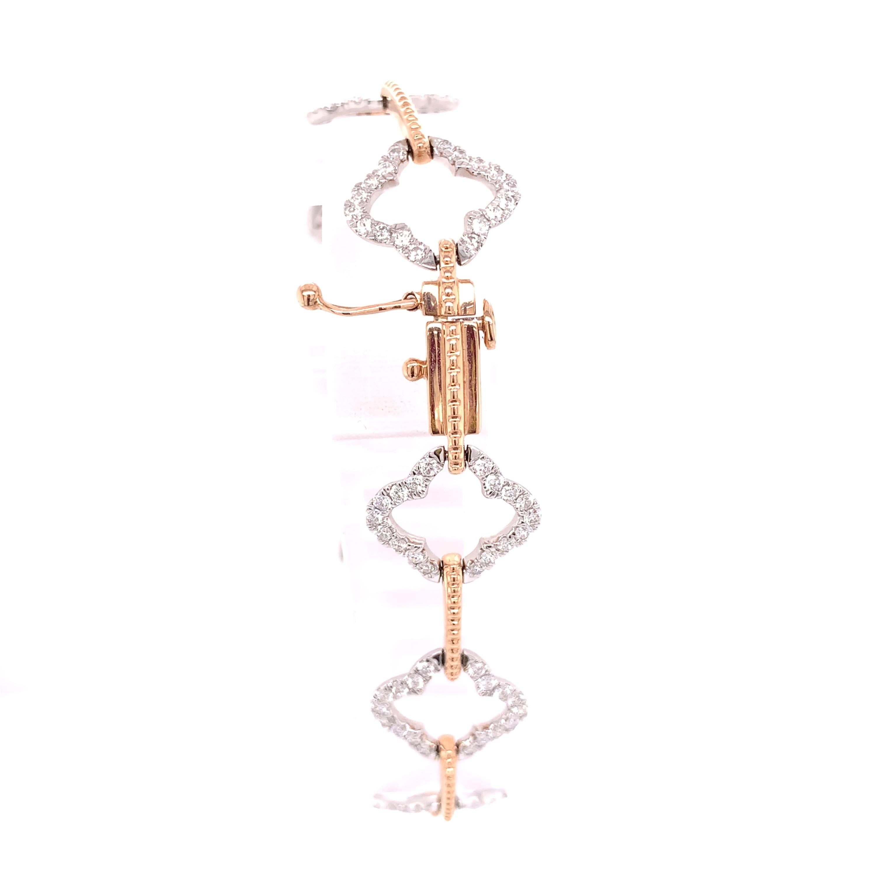 This bracelet is not your average tennis bracelet. This open clover style is incredibly unique! It was crafted in both 14 karat rose gold and white gold. The diamond weight is approximately 2 carats. This bracelet also comes with a safety clasp for