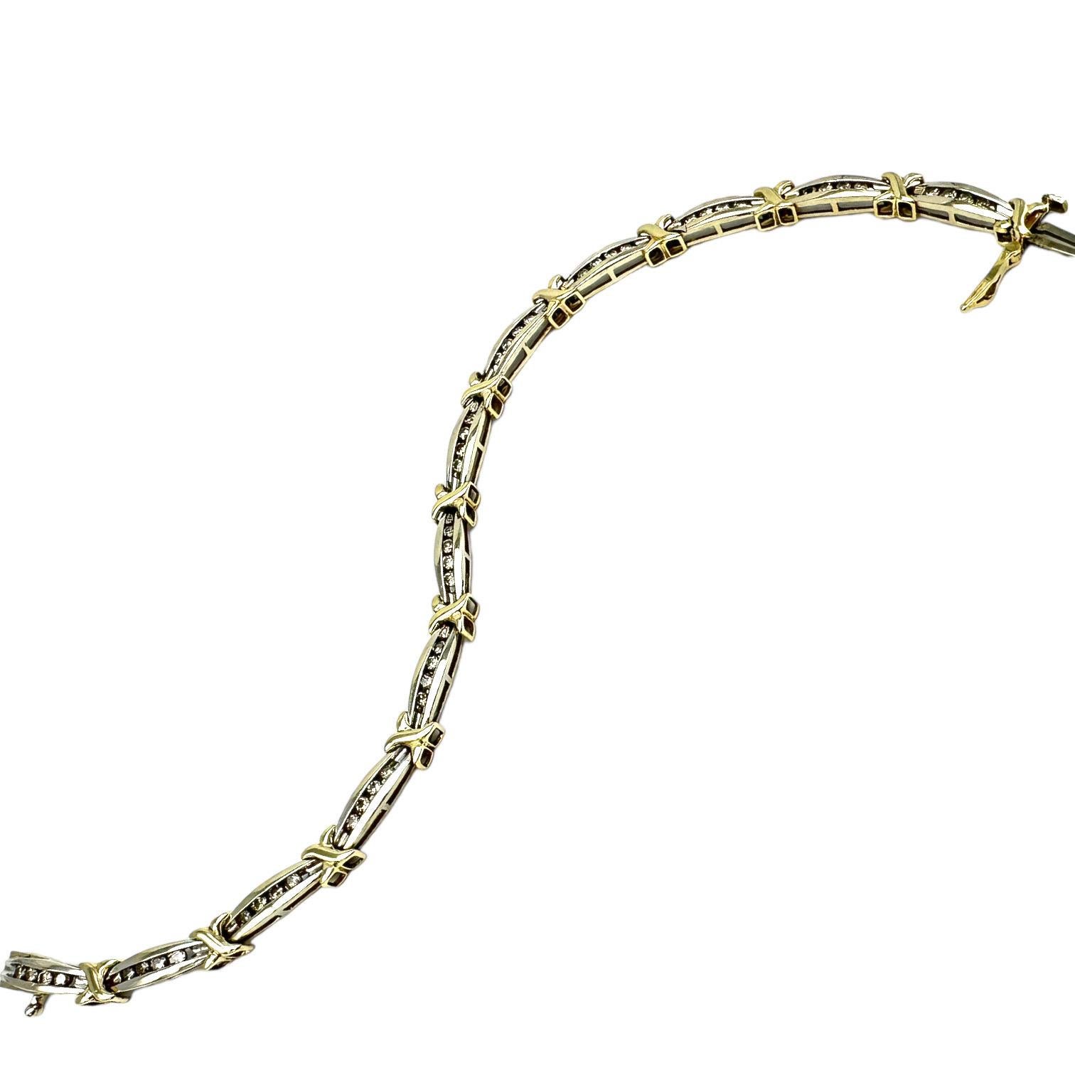 This is a contemporary-styled link tennis bracelet with diamonds set in channel bars separated by the iconic 'X,