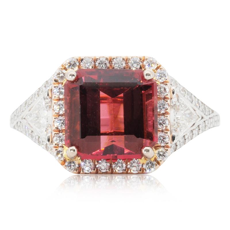 A gorgeous two toned ring with a dazzling 2.98 carat emerald natural rubellite. It has 0.94 carat of side diamonds which add more to its elegance. The jewelry is made of 14k pink and white gold with a high quality polish. It comes with IGI