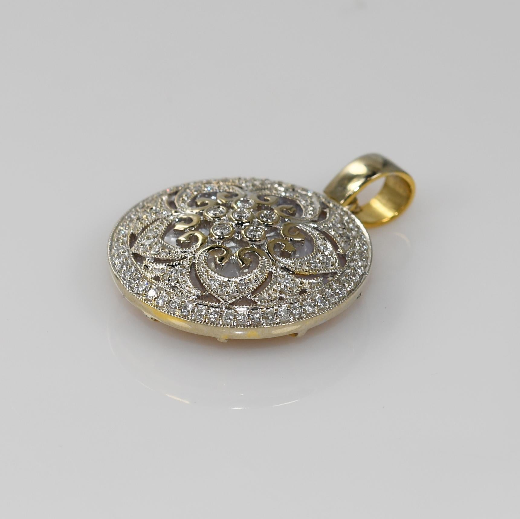 Custom-made diamond and mother of pearl in 14k white gold and 14k yellow gold reverse.
Tests 14k and weighs 6.5 grams.
The front of the pendant has fancy and intricate metalwork in white gold.
The diamonds are round brilliant cuts, .30 total carats,