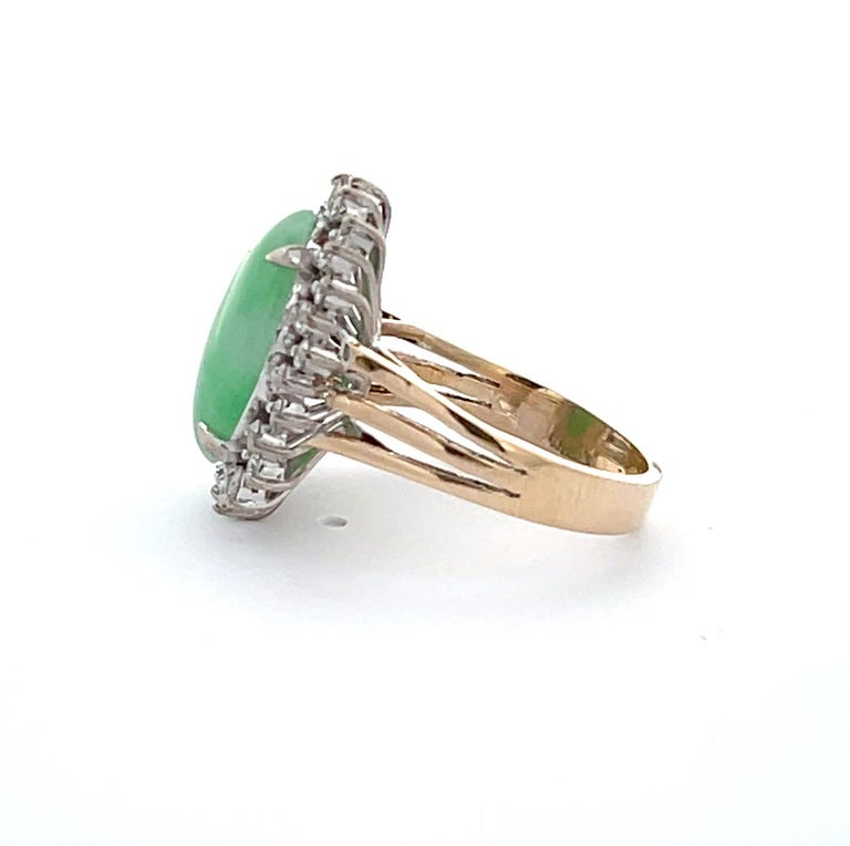 A one-of-a-kind cocktail ring that would be perfect for your collection! 

The center stone features an oval cut Green Jade ( 15mm x 11 mm) that is held in by four prongs and is surrounded by Twenty-Seven (27) Round Brilliant Cut Diamonds. The total