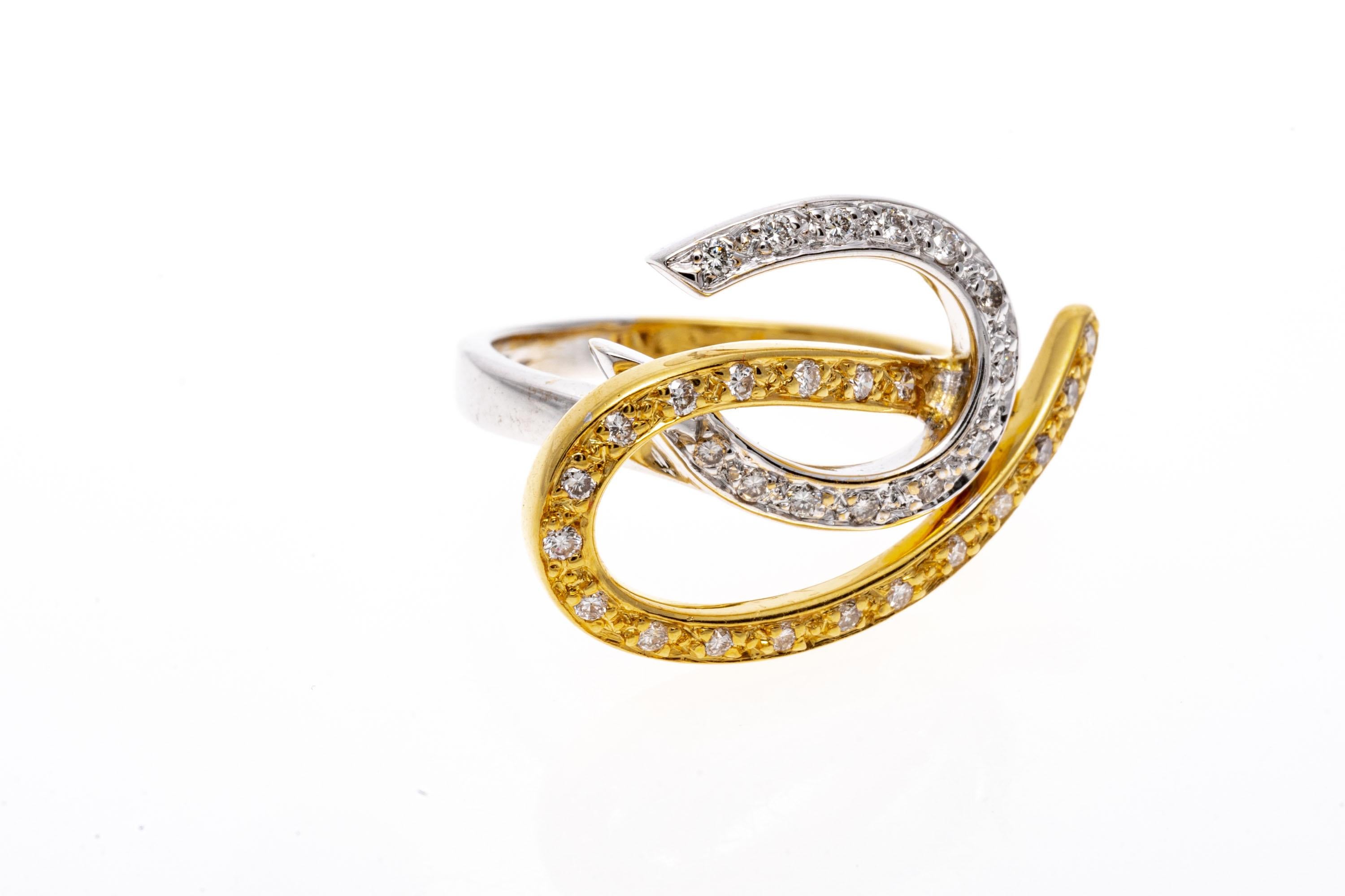 14k white gold and yellow vermeil ring. This lyrical looking ring is made up of a beautiful white gold swirl, and a graceful yellow vermeil swirl, set with round faceted diamonds, approximately 0.29 TCW.
Marks: None, tests 14k
Dimensions: 29/32