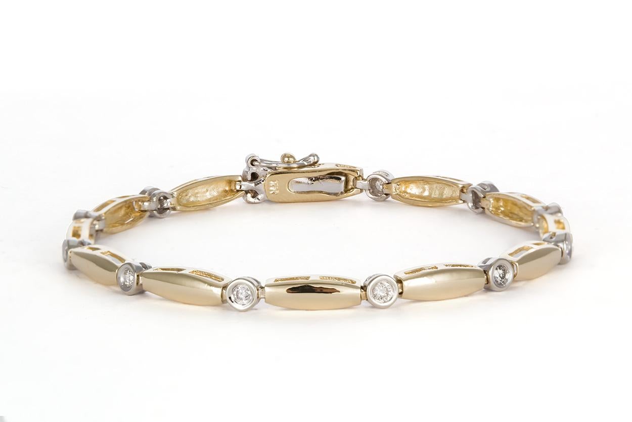 We are is pleased to present this 14k Two Tone White & Yellow Gold Diamond Bracelet. It features a two tone design with push style clasp and additional safety clasp. The bracelet will fit up to a 7″ wrist. It is in very good condition and was