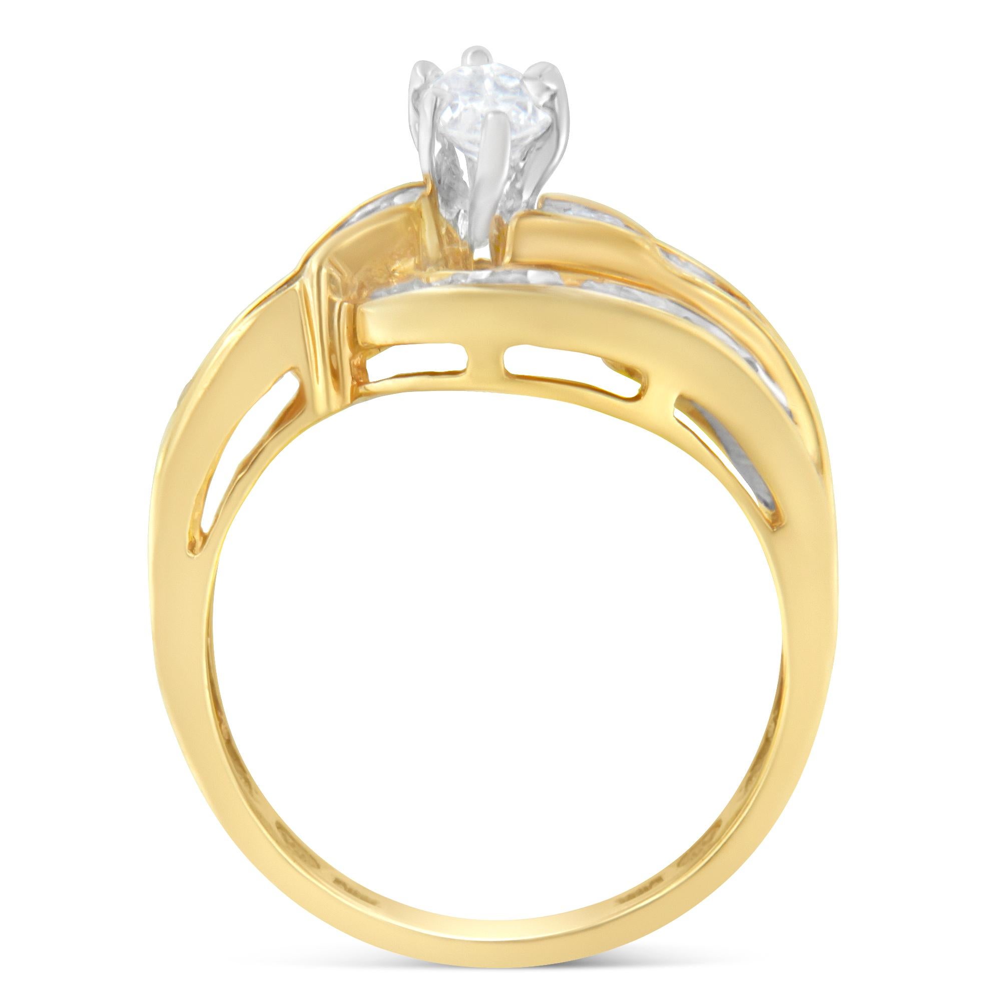 A central marquise cut diamond is the main feature of this elegant design that also features a bypass band crafted in 14 karat yellow gold and set with diamond baguettes and round diamonds. It has a total diamond weight of 1 carat.

