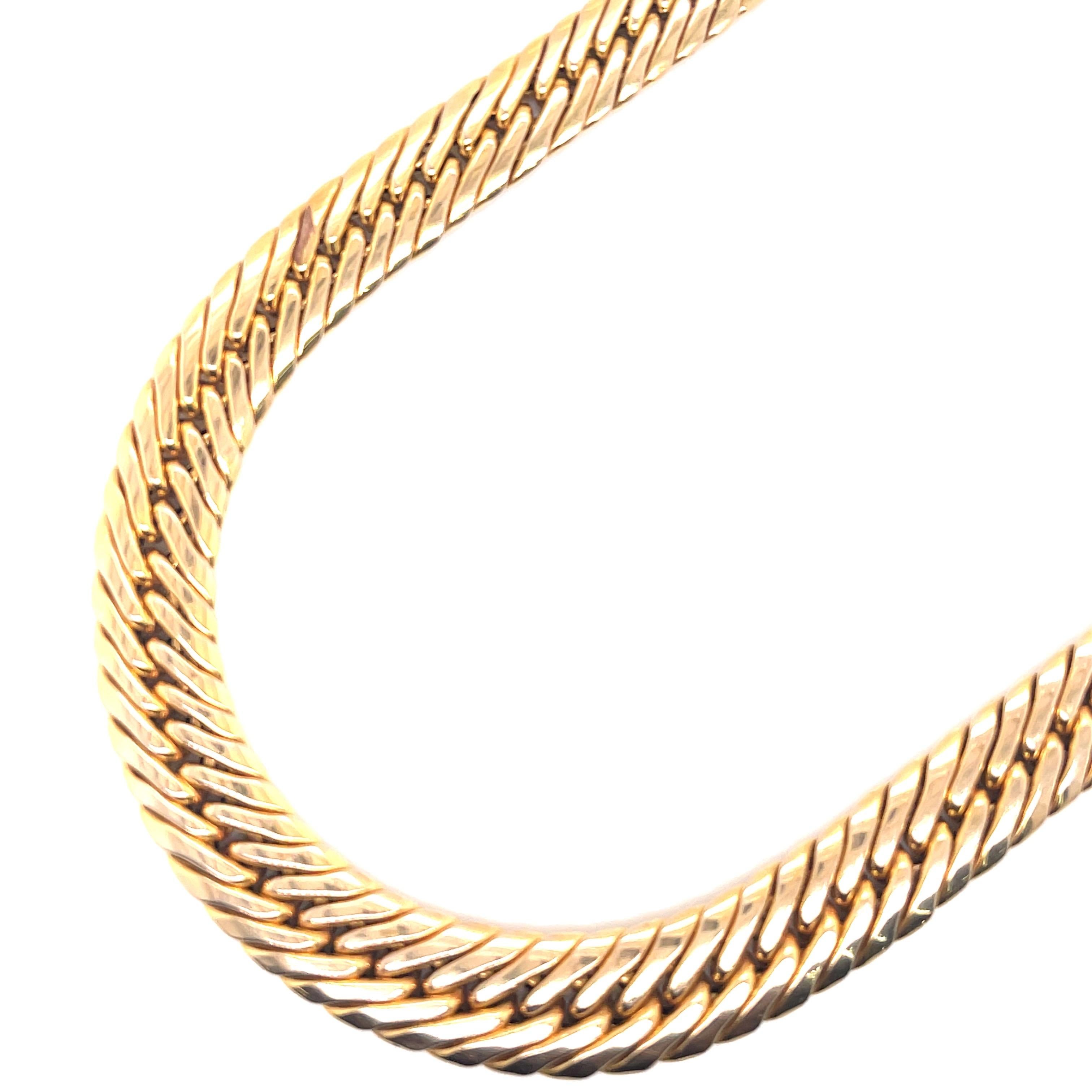 Signed UnoAerre this snake motif necklace is crafted in 14 karat yellow gold weighing 36.1 grams. 
Made in Italy