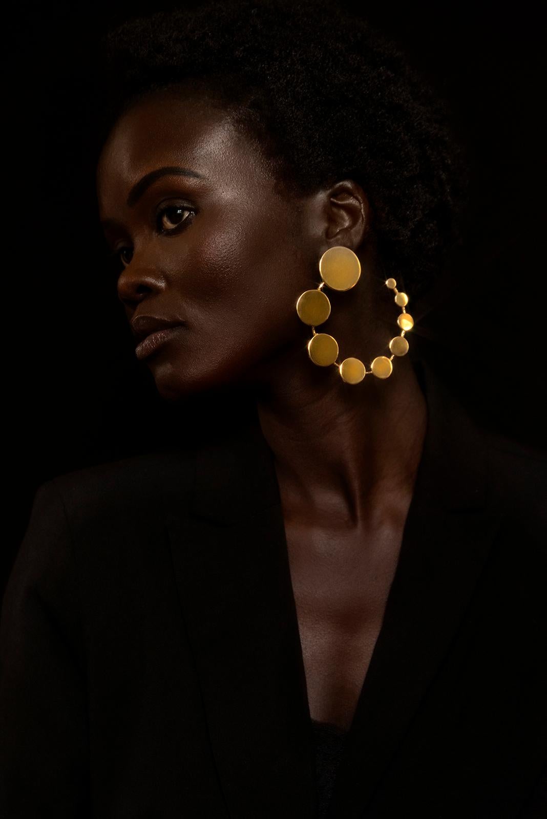 14K Vermeil 9 Disk Progression Hoop Earrings from Made by Malyia.

Made to order
Production time 3 weeks.

9 Disk earring with Progressively increasing disk. The geometric design is the classic hoop reimagined, signifying the process of gradually