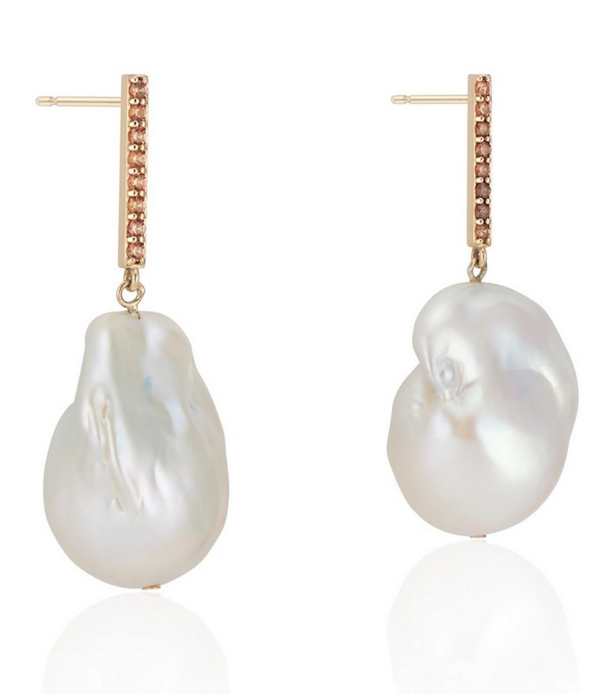 14K Vertical Yellow Gold Bar with a beautiful soft shade of orange sapphire and baroque pearl drop earring.

The hue of orange sapphire against the high polish yellow gold contrasts beautifully with the pearl, and the shimmering vertical bar gives