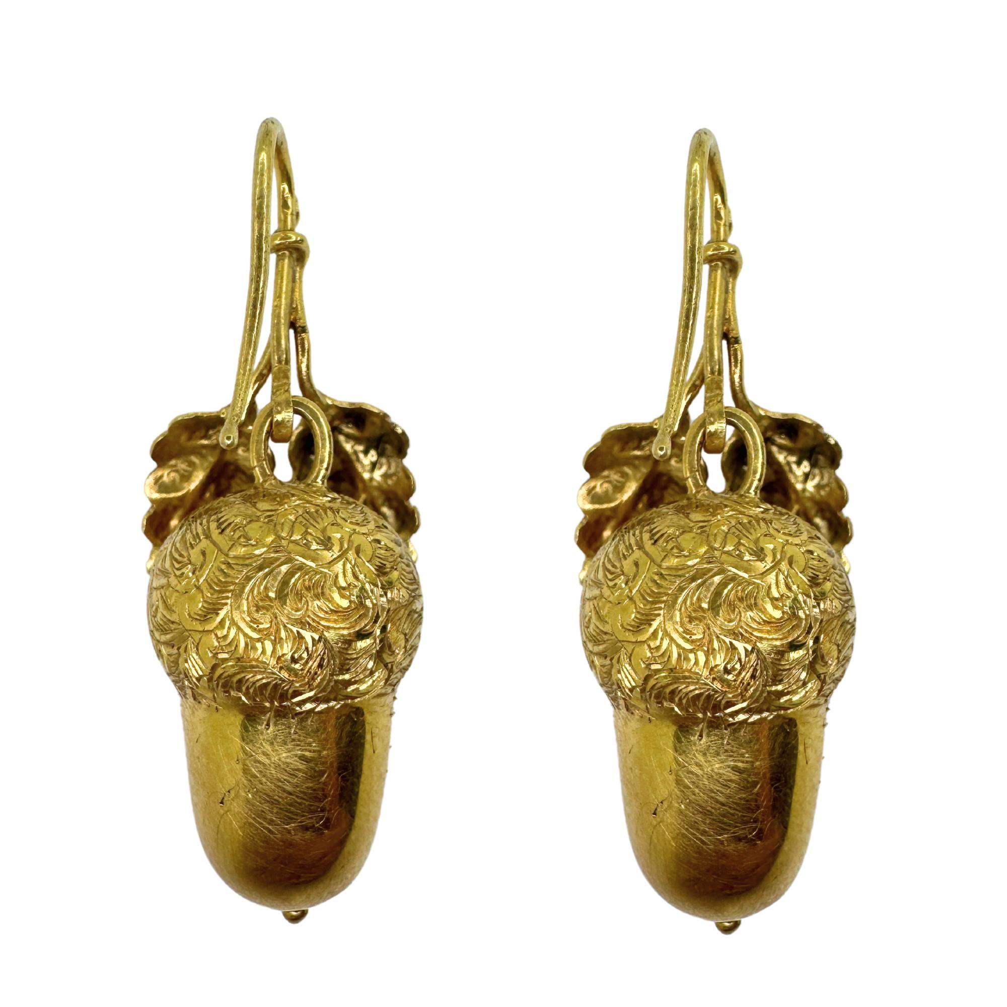 Add a touch of vintage elegance to your wardrobe with these 14k Victorian Acorn Earrings. Crafted from high-quality 14k yellow gold, these earrings showcase intricate detailing and measure 1.75 inches in length. In good condition with minor surface