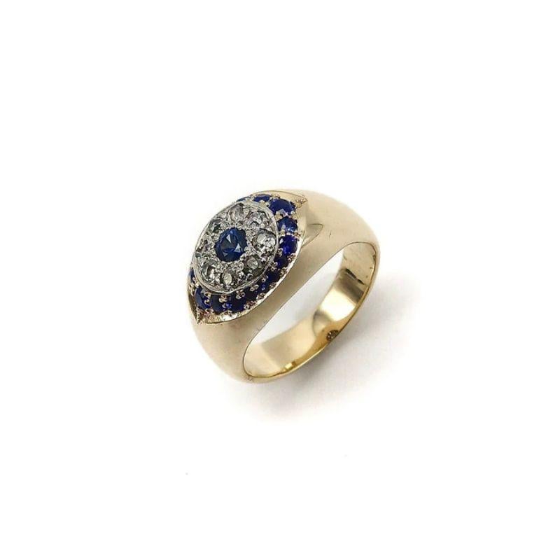 Originally, a 14 karat Victorian era ring with a circle of diamonds surrounding the central sapphire stone, we added the exterior eye shape of graduated sapphires and engravings to transform the piece into a distinct eye shape. Our design is