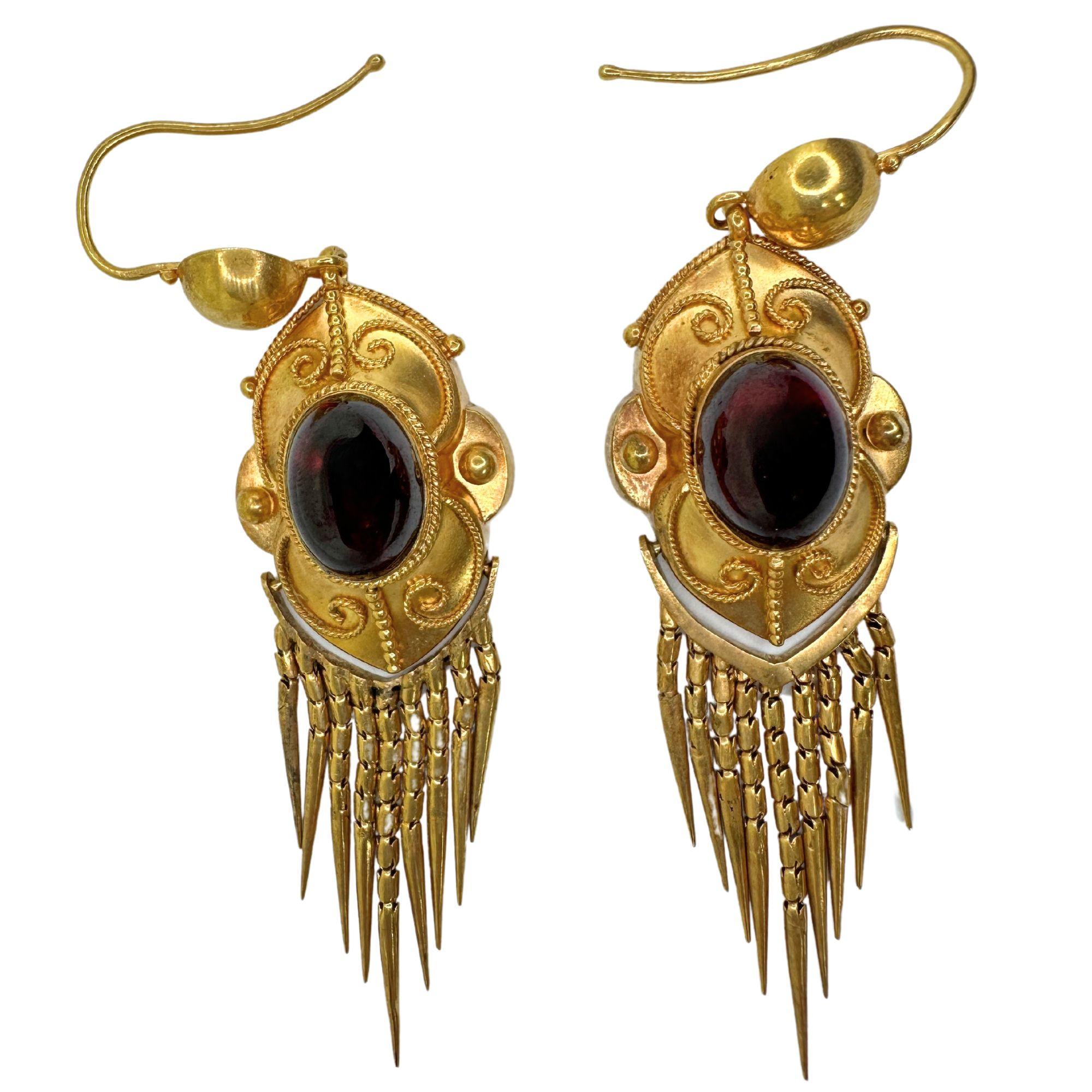 Add a touch of Victorian elegance to your outfit with our 14k Gold and Garnet Tassel Earrings. Crafted with detailed 14k yellow gold and featuring stunning garnet gemstones, these earrings measure 2.25 inches in length and weigh 6.7 grams. In good