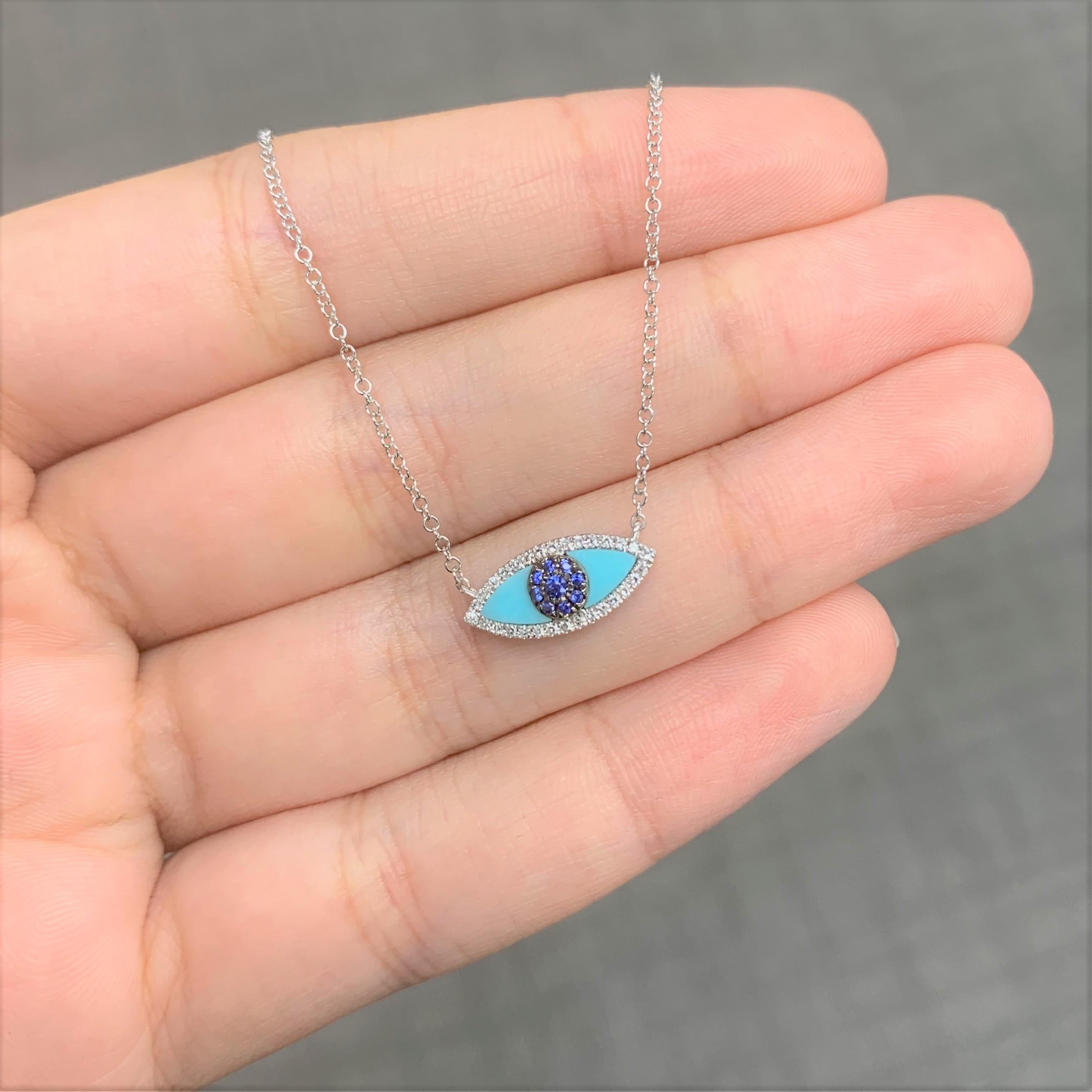 This striking Evil Eye Necklace crafted of 14K Gold features Luscious Blue Sapphires which trace the outline of a Turquoise eye, with white diamonds ensuring that the gaze won't waver. Diamond Weight is approximately 0.08ct ans Sapphire weight is