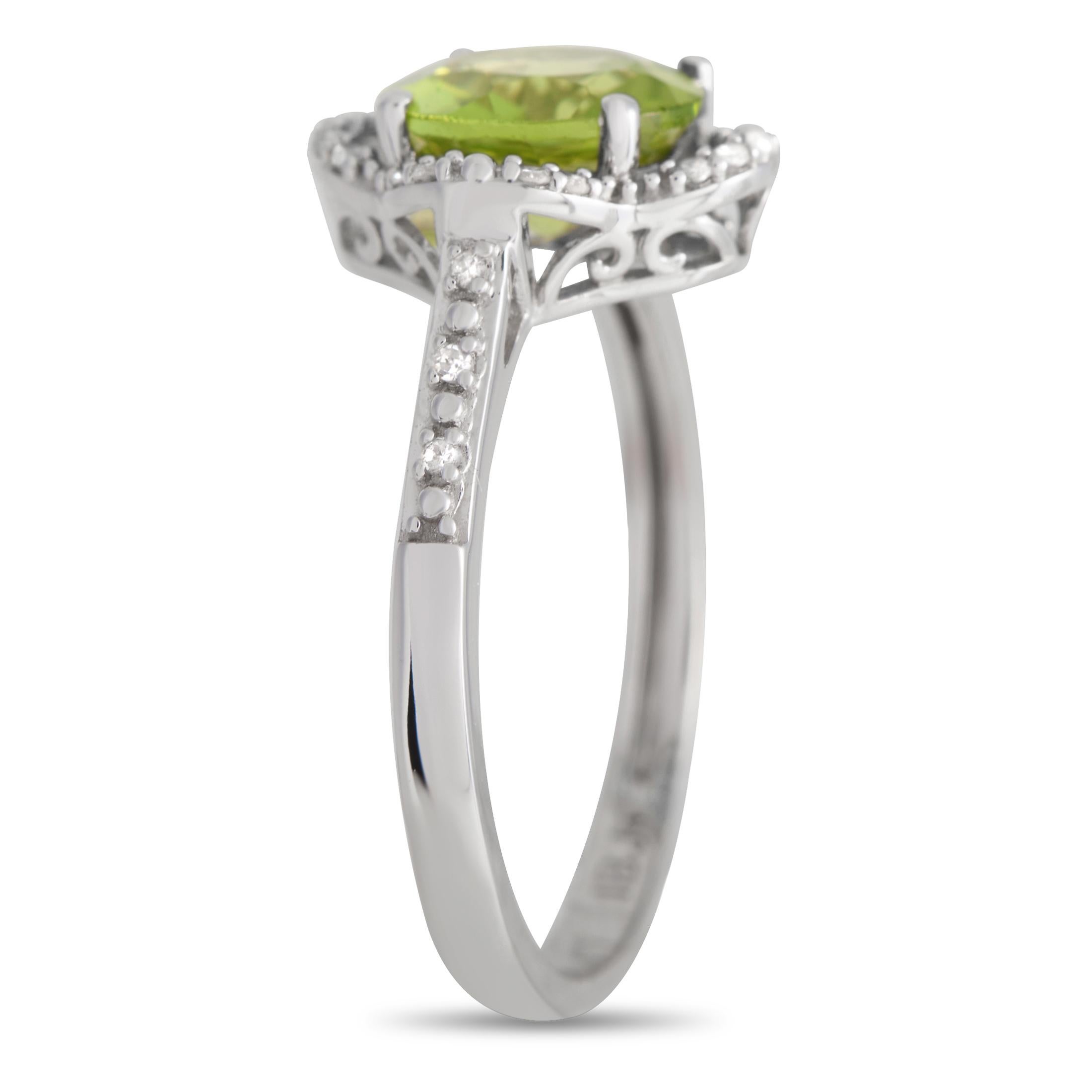 Bearing what they call the 'stone of compassion,' this peridot ring glows beautifully with its bright, happy green hue. The round peridot sits at the center of a quatrefoil setting with a diamond-traced outline and swirl embellishment. The shoulders