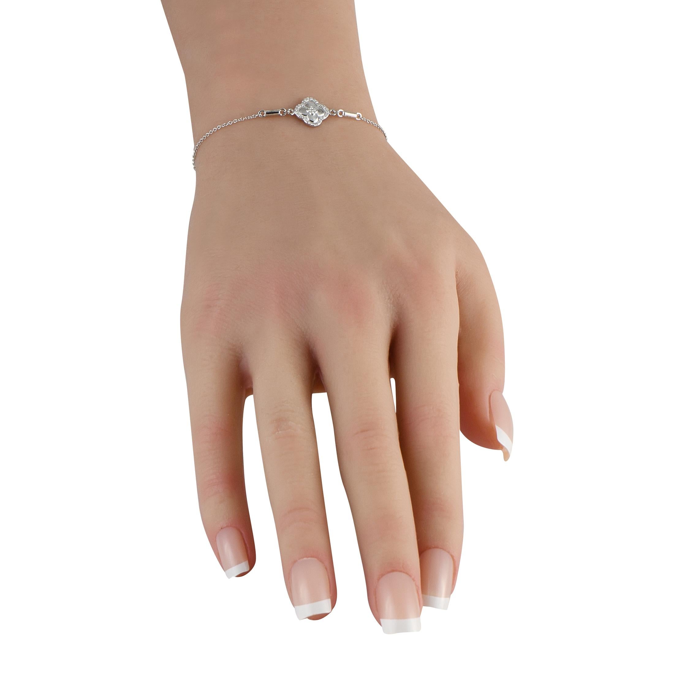 This exquisitely crafted bracelet is simple and elegant. At the center of the delicate chain, a quatrefoil motif shines to life thanks to inset Diamonds totaling 0.10 carats. Its crafted from 14K White Gold and measures 7.25 long.This jewelry piece
