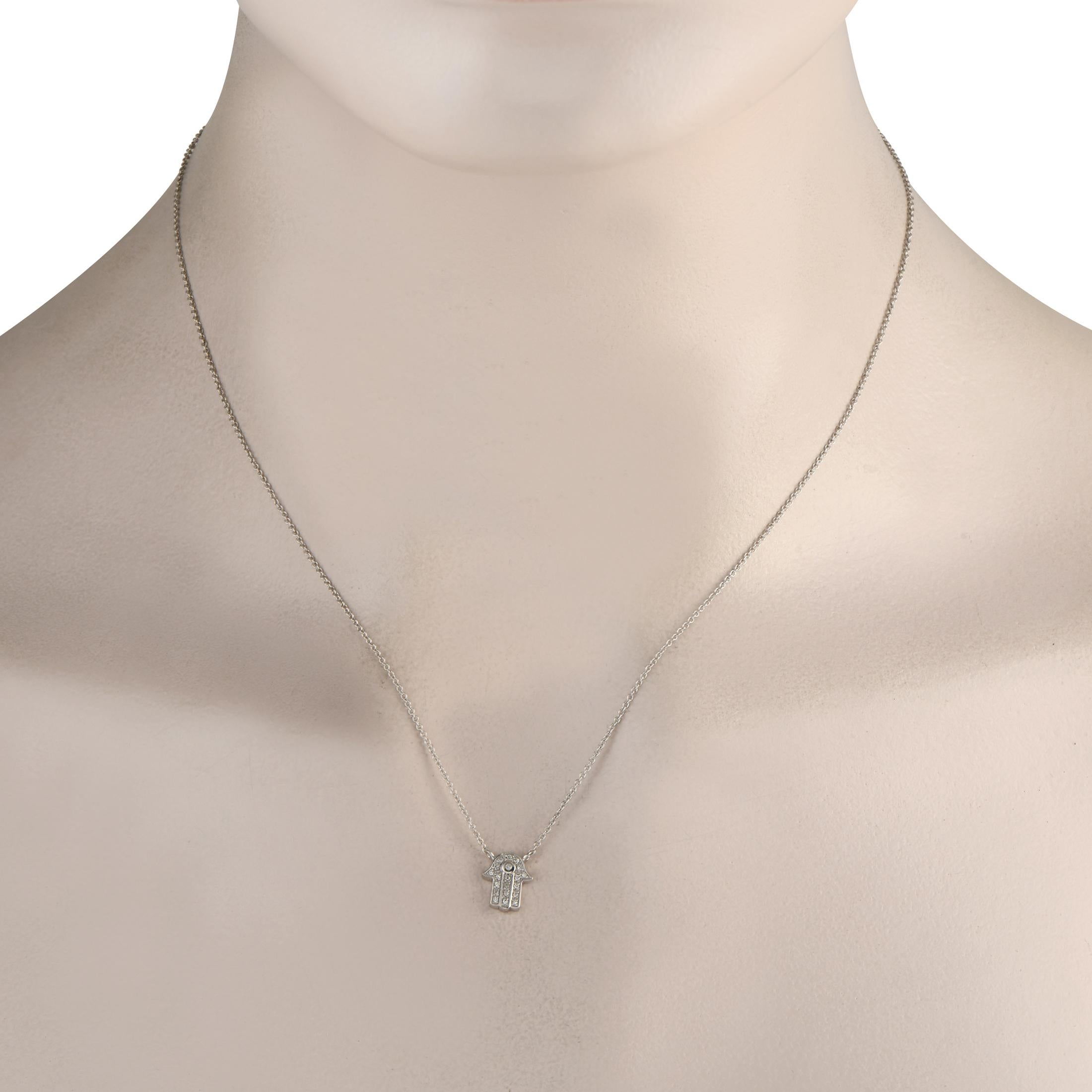 This 14K White Gold necklace is subtle and elegant. A symbol of protection and good luck, the Hamsa pendant shines to life thanks to inset Diamonds totaling 0.10 carats. The pendant measures 0.38 long by 0.25 wide and is suspended from an 18