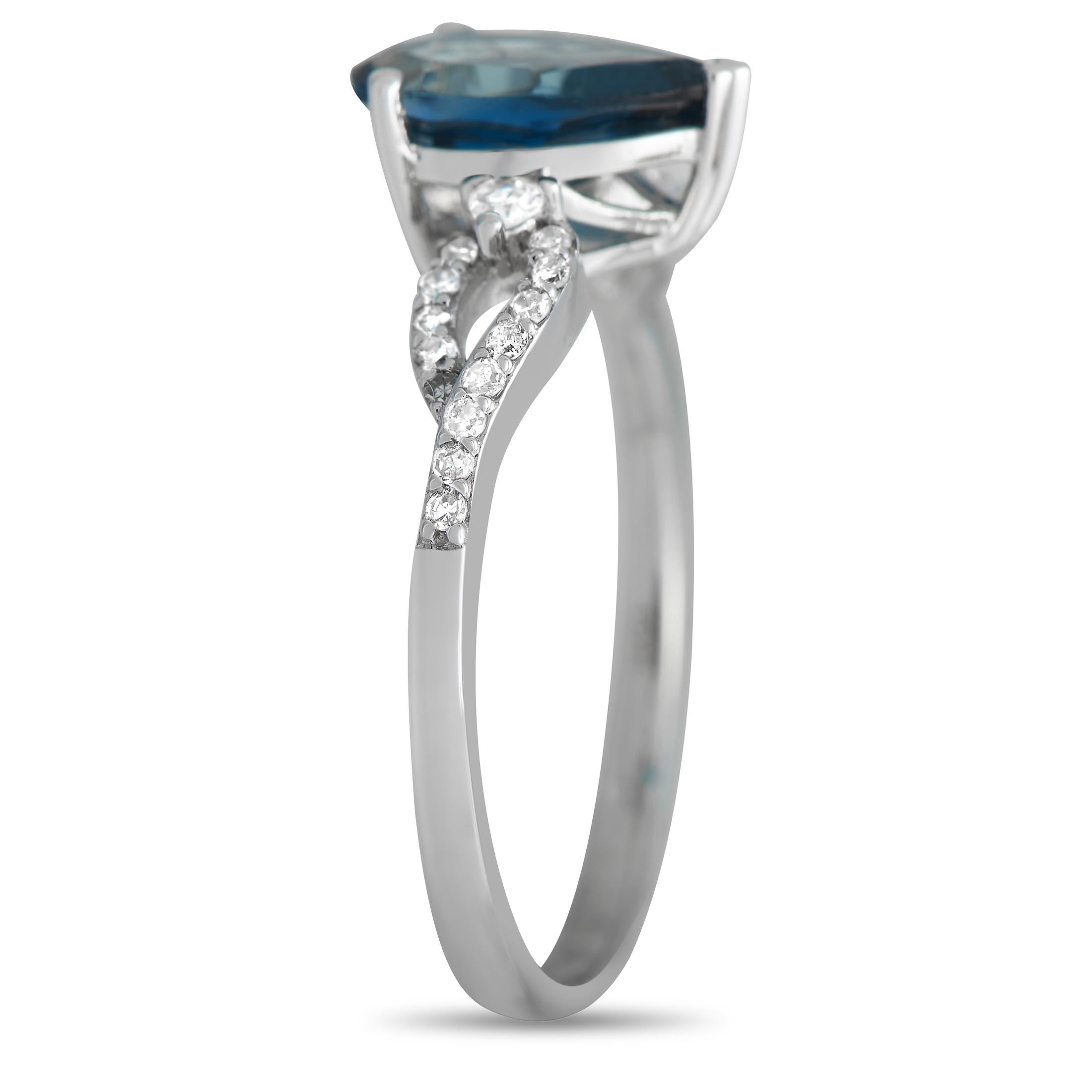 At the center of this rings intricate 14K White Gold setting, a breathtaking Topaz gemstone with a captivating blue hue serves as a stunning focal point. Ideal for everyday wear, this piece features a 2mm wide band and a 6mm top height. Diamonds
