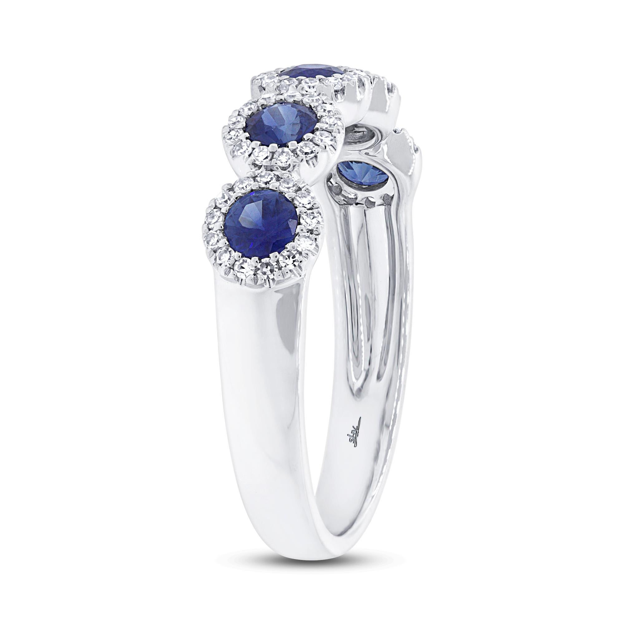 Show-stopping blue sparkle and contemporary elegance describe this gorgeous sapphire eternity ring. It features five dainty blue sapphires, each encircled by a ravishing diamond halo. Flawlessly polished for a luxurious look and feel. A perfect gift