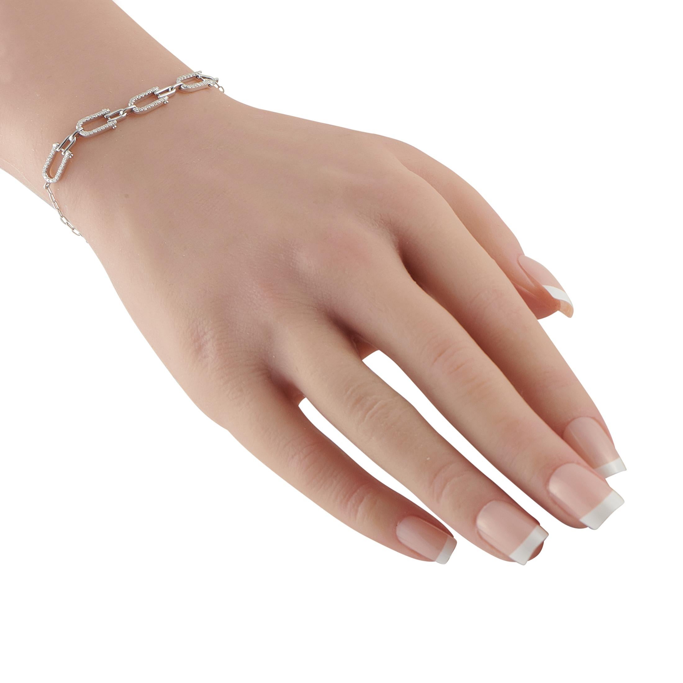 Interlocking links make this luxury bracelet impossible to ignore. Set in 14K White Gold, sparkling Diamonds totaling 0.25 carats highlight the uniquely elegant design. It measures 7.25 long.This jewelry piece is offered in brand new condition and